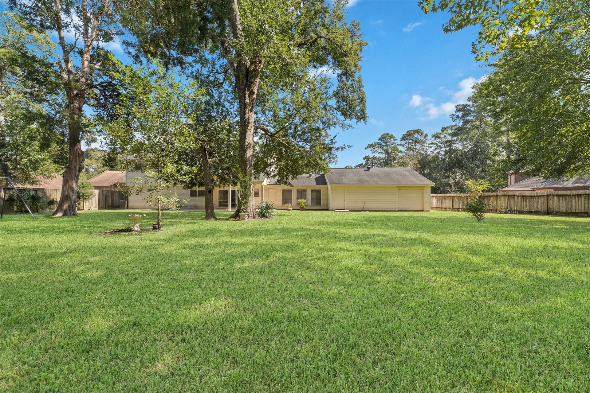 13007 New Cypress Drive, Cypress, TX 77429 Room to run, play, entertain, or simply unwind! This expansive, tree-shaded backyard offers a beautiful combination of open lawn, towering mature trees, and a peaceful natural setting. Whether it's a game of catch, weekend gatherings, or quiet afternoons outdoors, there's room for everyone to enjoy