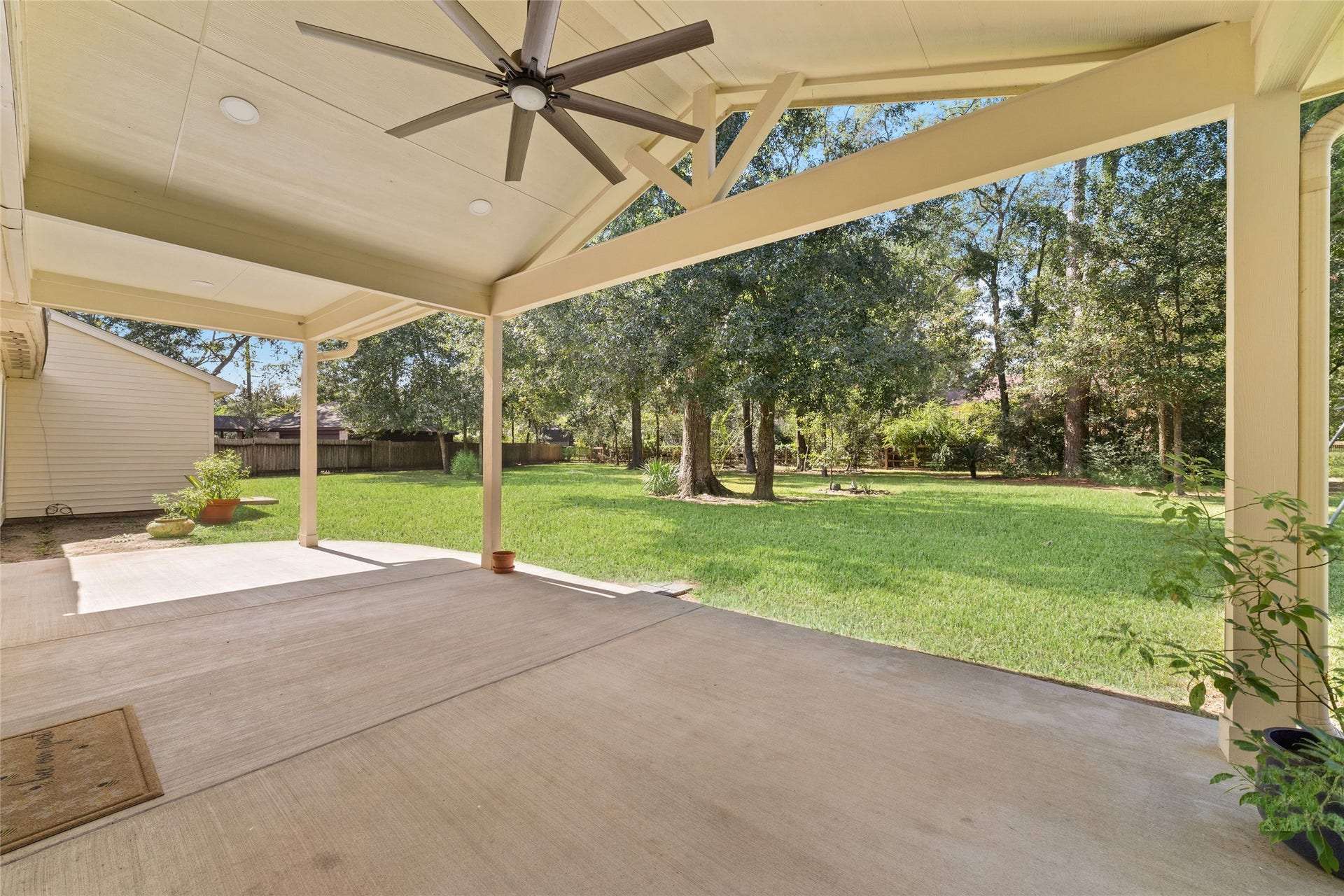 13007 New Cypress Drive, Cypress, TX 77429 Morning coffee surrounded by nature, an evening cocktail while the kids play in the backyard, or a relaxed dinner al fresco with family and friendsthis expansive covered patio is made for enjoying life's simple pleasures. With a vaulted ceiling, exposed beams, and ceiling fan, it's a beautiful extension of the home's living space, overlooking the sprawling lawn and mature shade trees