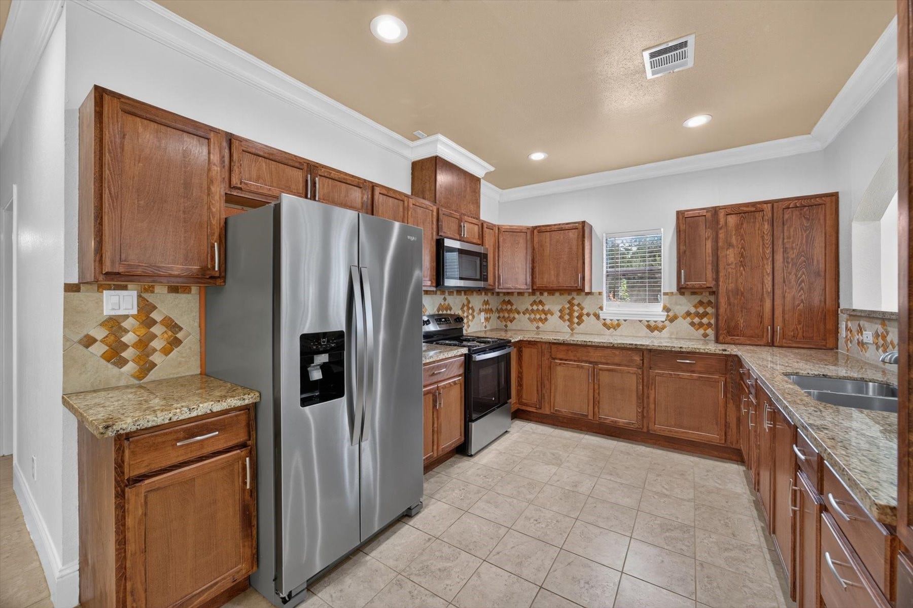 22214 Foxbend Drive, Katy, TX 77449 Kitchen with Stainless Steel Appliances & Custom Cabinetry