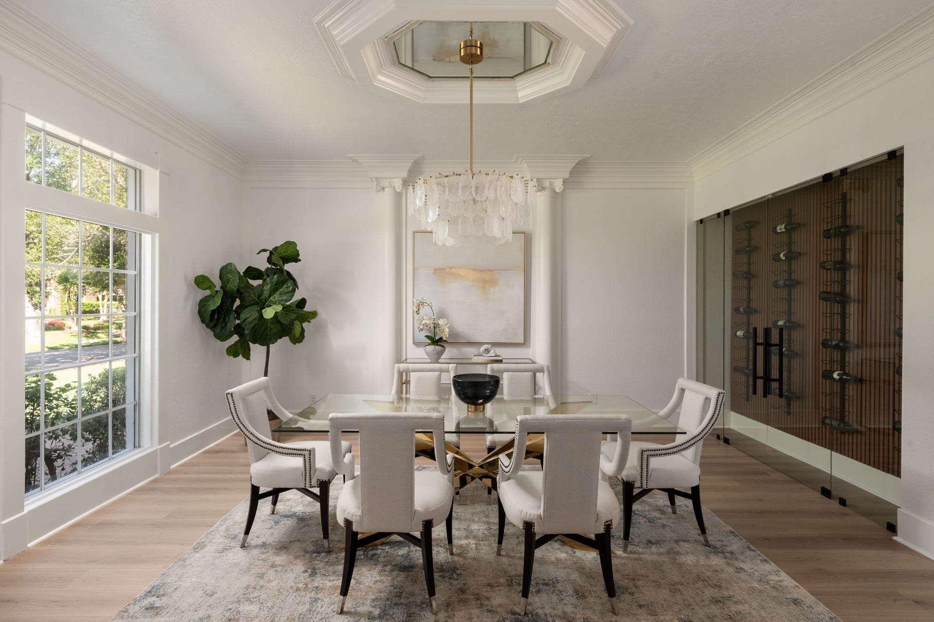 93 Greensward Lane, Sugar Land, TX 77479 The formal dining room was designed for entertaining with updated lighting, detailed millwork, and generous proportions for larger gatherings. Oversized windows overlook the front landscaping while bringing additional depth to the room. The space transitions naturally into the foyer and adjacent living areas.