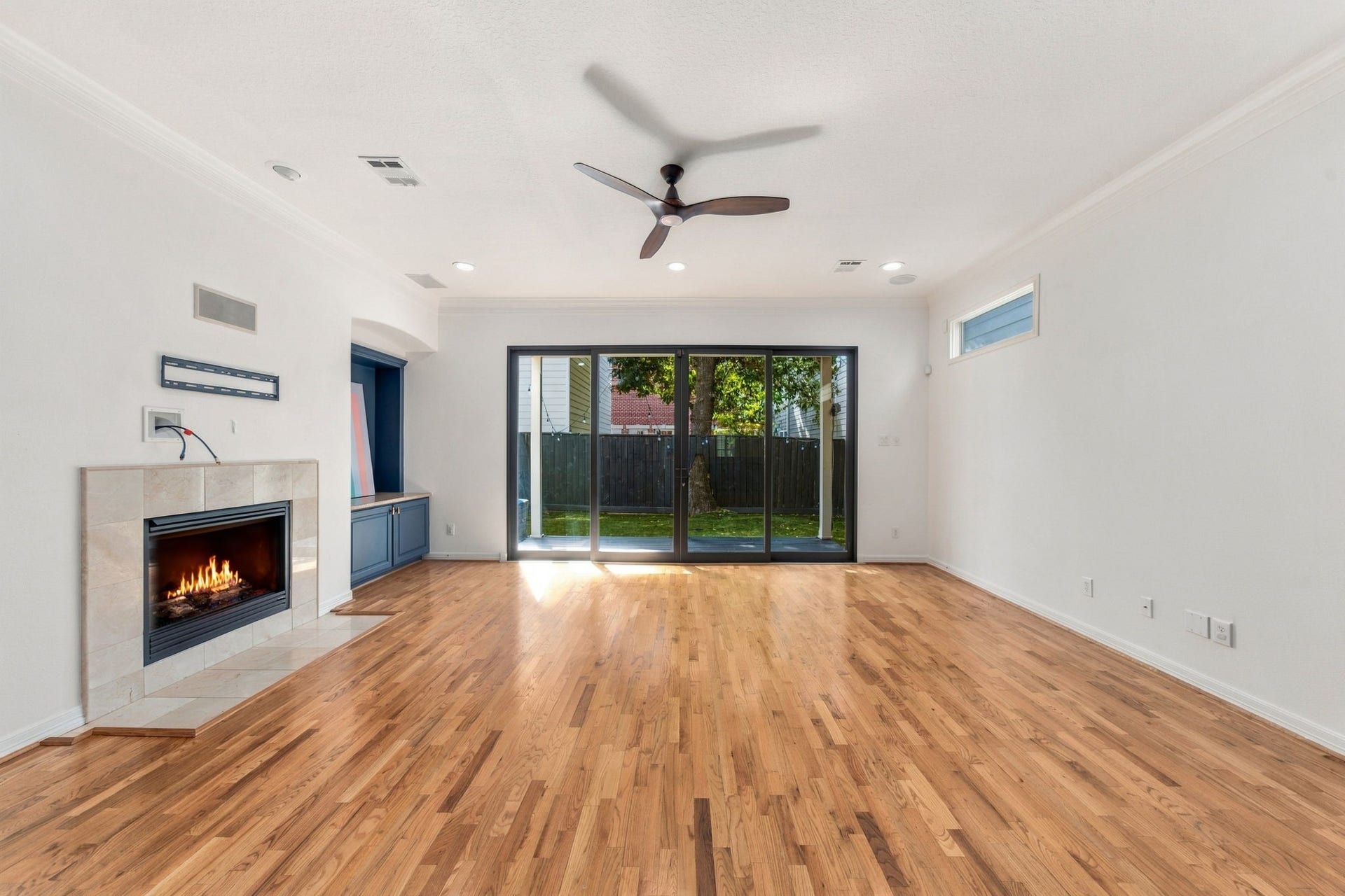 6113 Maxie Street, Houston, TX 77007 A closer look at the living room's hardwood flooring, fireplace & direct access to the outdoor living area.