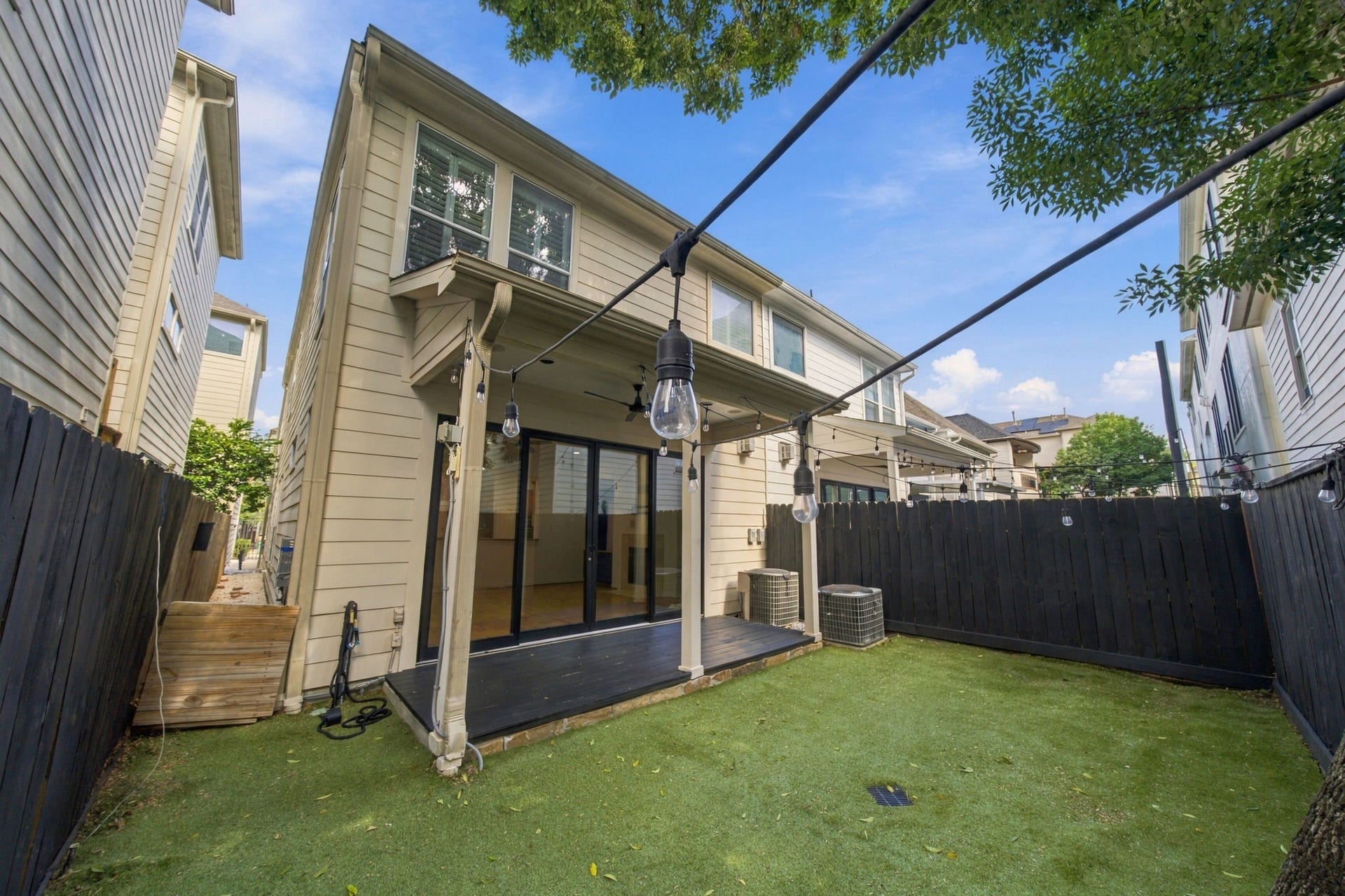 6113 Maxie Street, Houston, TX 77007 Another view of the private backyard, offering a wonderful balance of shaded patio space & easy-care turf for outdoor enjoyment.