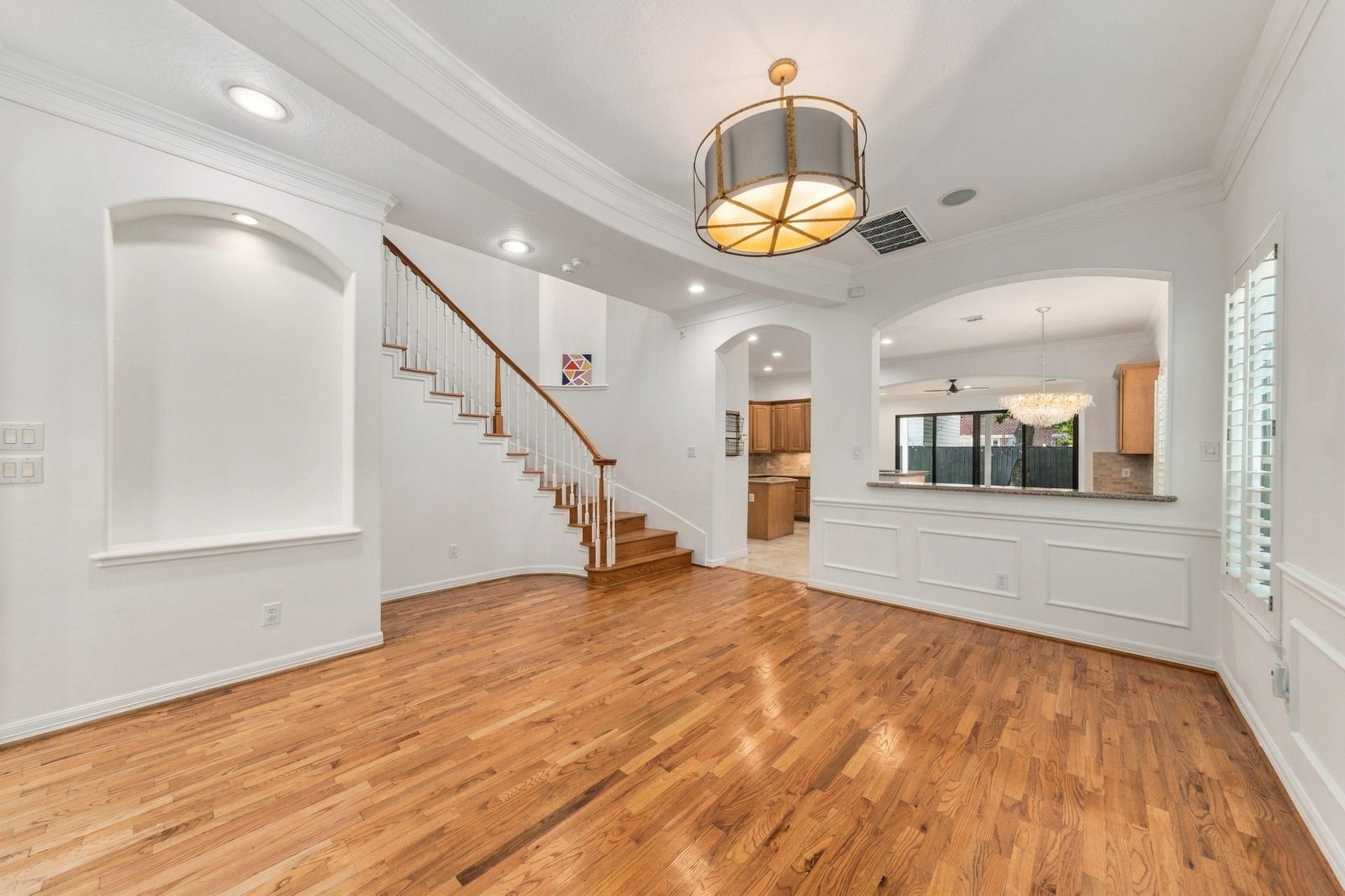 6113 Maxie Street, Houston, TX 77007 Another view of the formal dining room, showcasing the hardwood flooring, architectural details & open connection to the kitchen.