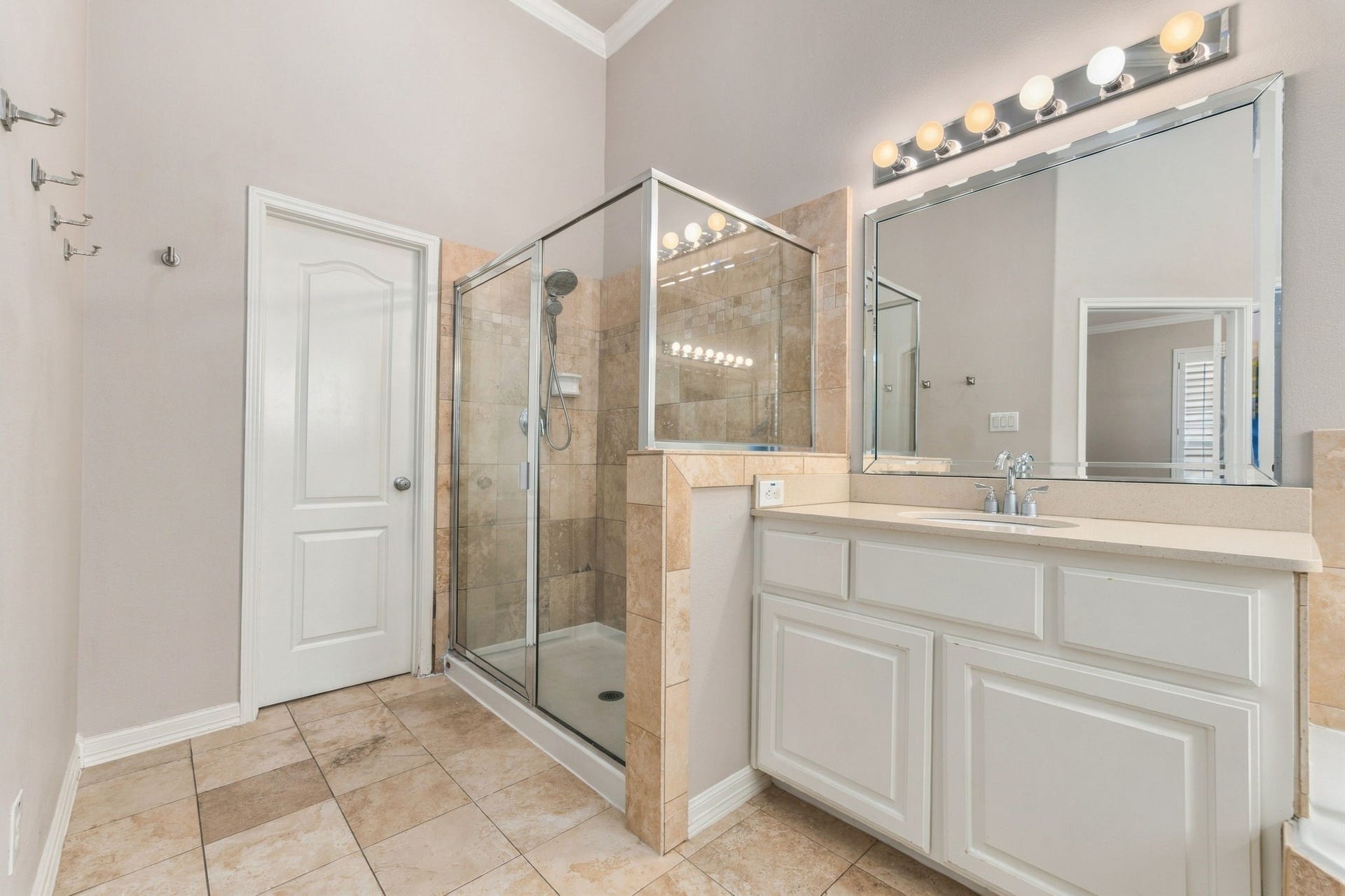 6113 Maxie Street, Houston, TX 77007 A separate glass-enclosed shower with tile surround & handheld showerhead completes the primary bath.