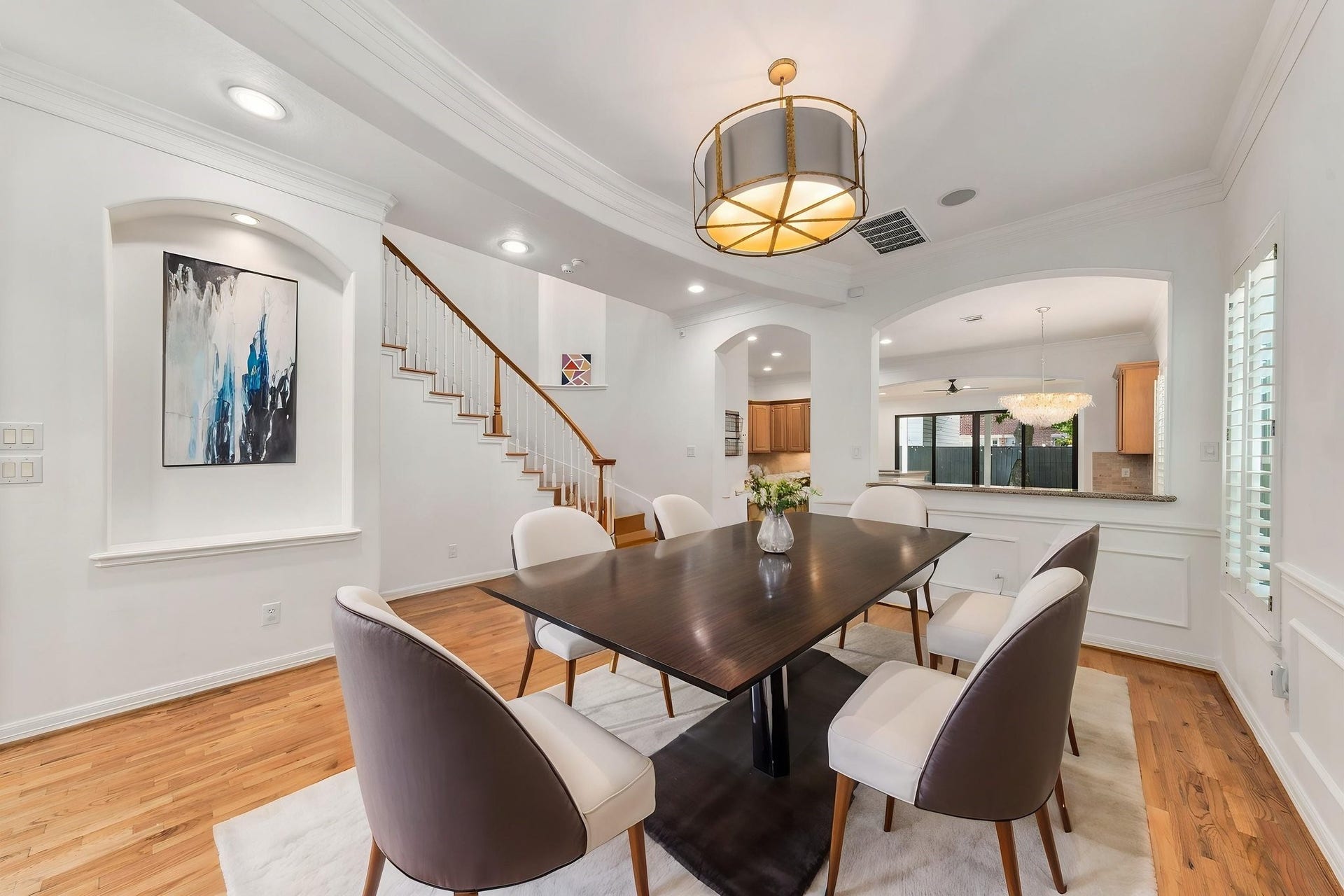 6113 Maxie Street, Houston, TX 77007 The formal dining room features beautiful hardwood floors, classic millwork, plantation shutters & a striking designer light fixture. An elegant setting for both everyday dining & entertaining. Virtually staged.