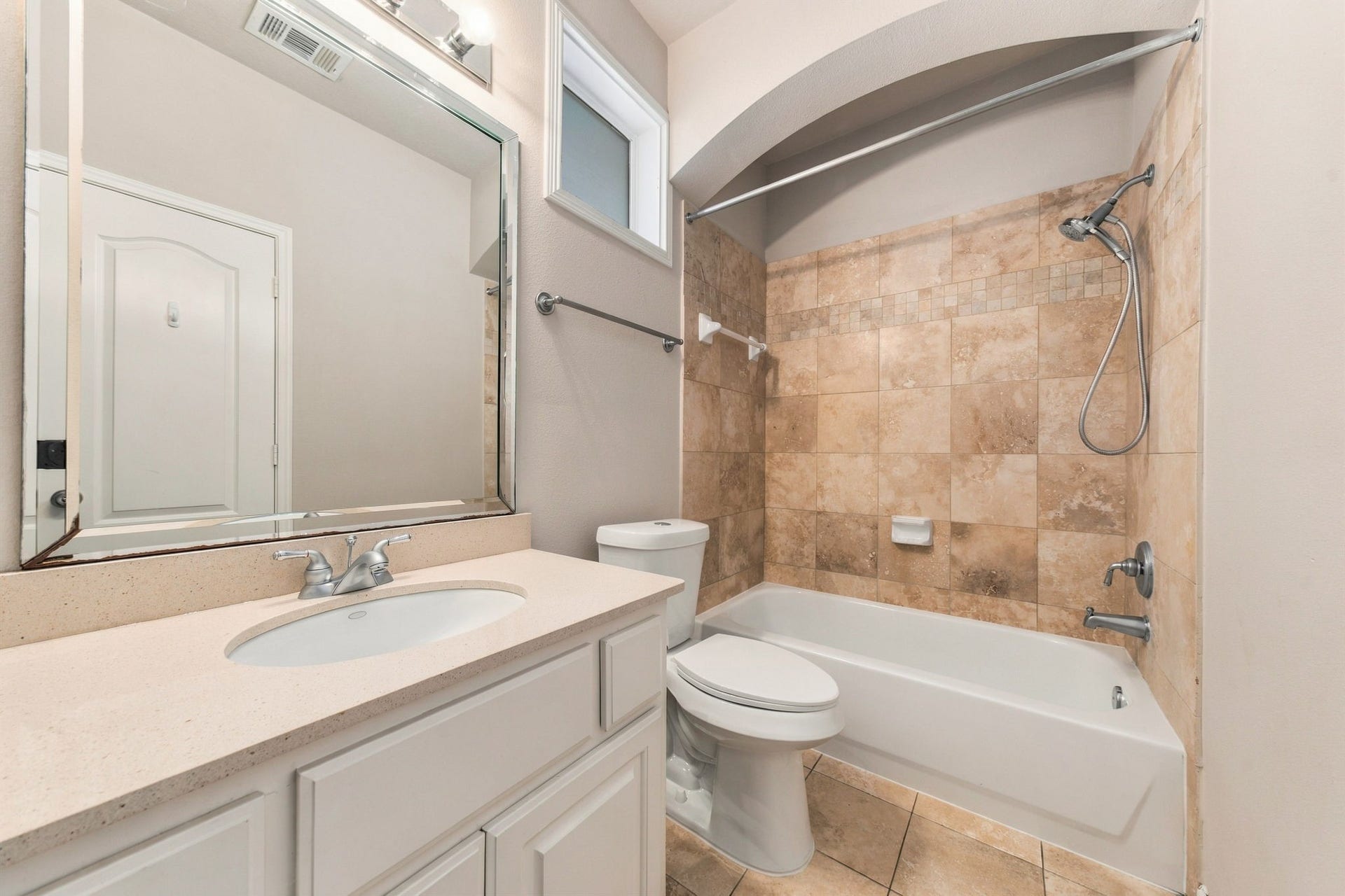 6113 Maxie Street, Houston, TX 77007 Upstairs secondary bathroom features a tub/shower combination with tile surround, spacious vanity & neutral finishes.