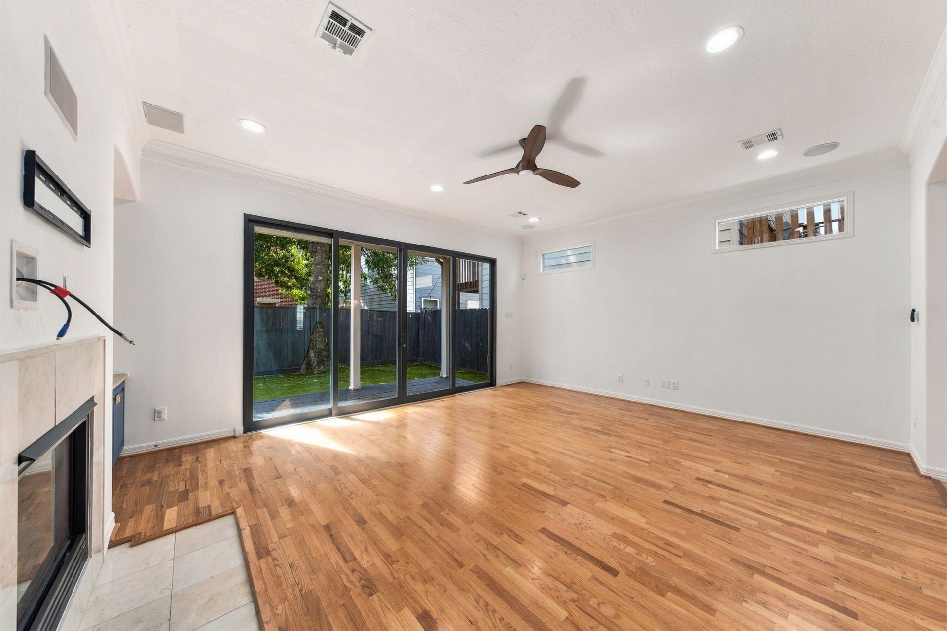 6113 Maxie Street, Houston, TX 77007 Another view of the living room, highlighting the natural light from the sliding glass doors and direct access to the covered patio & backyard.