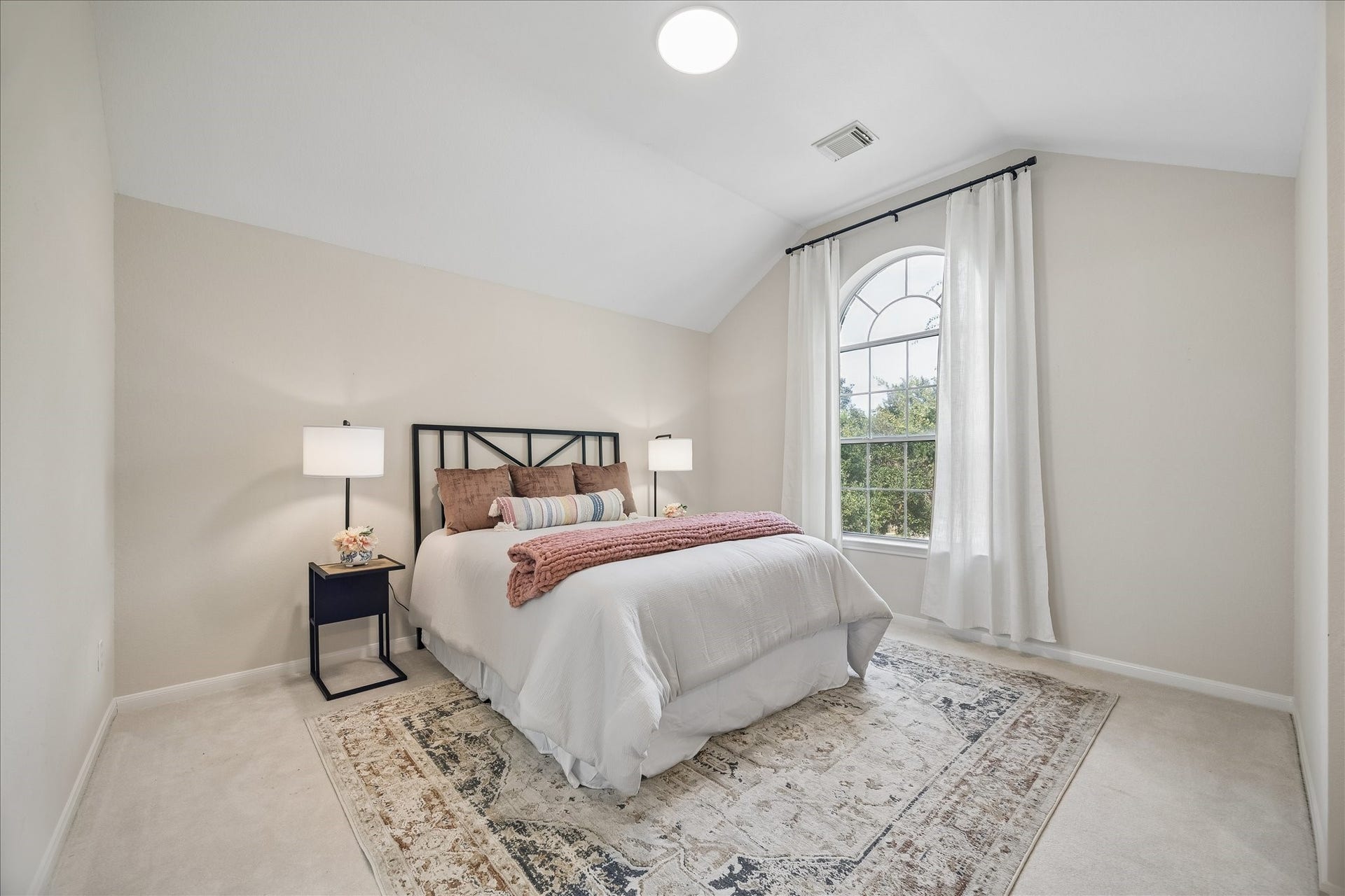 7503 Stone Arbor Drive, Sugar Land, TX 77479 This spacious secondary bedroom #2 features soaring ceilings, abundant natural light, and a large arched window that creates a bright and comfortable retreat.