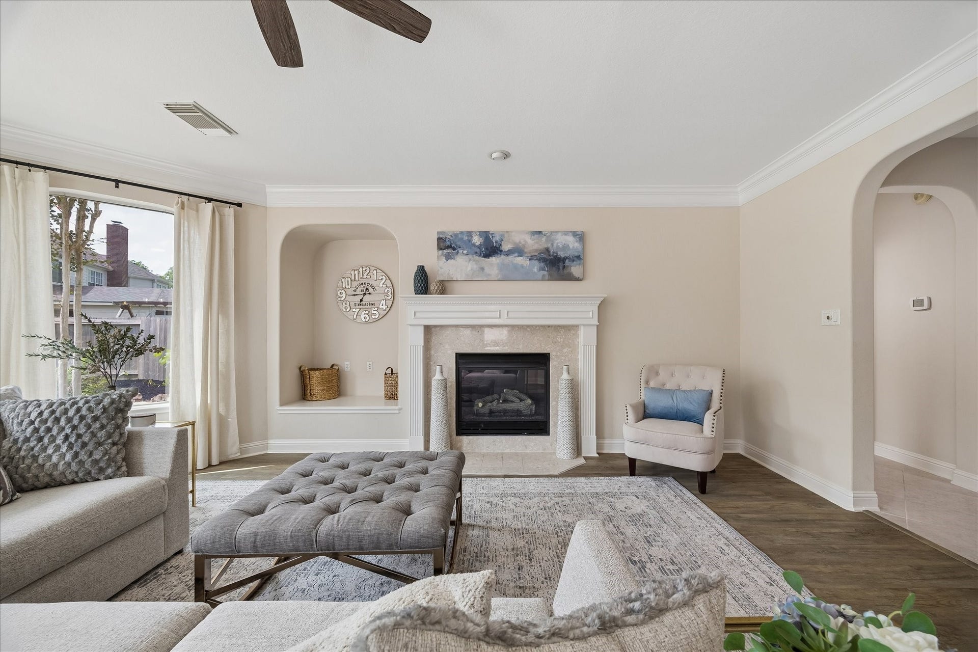 7503 Stone Arbor Drive, Sugar Land, TX 77479 Architectural niches and a striking fireplace surround add warmth and character to this inviting gathering space. Expansive windows provide peaceful views of the backyard.