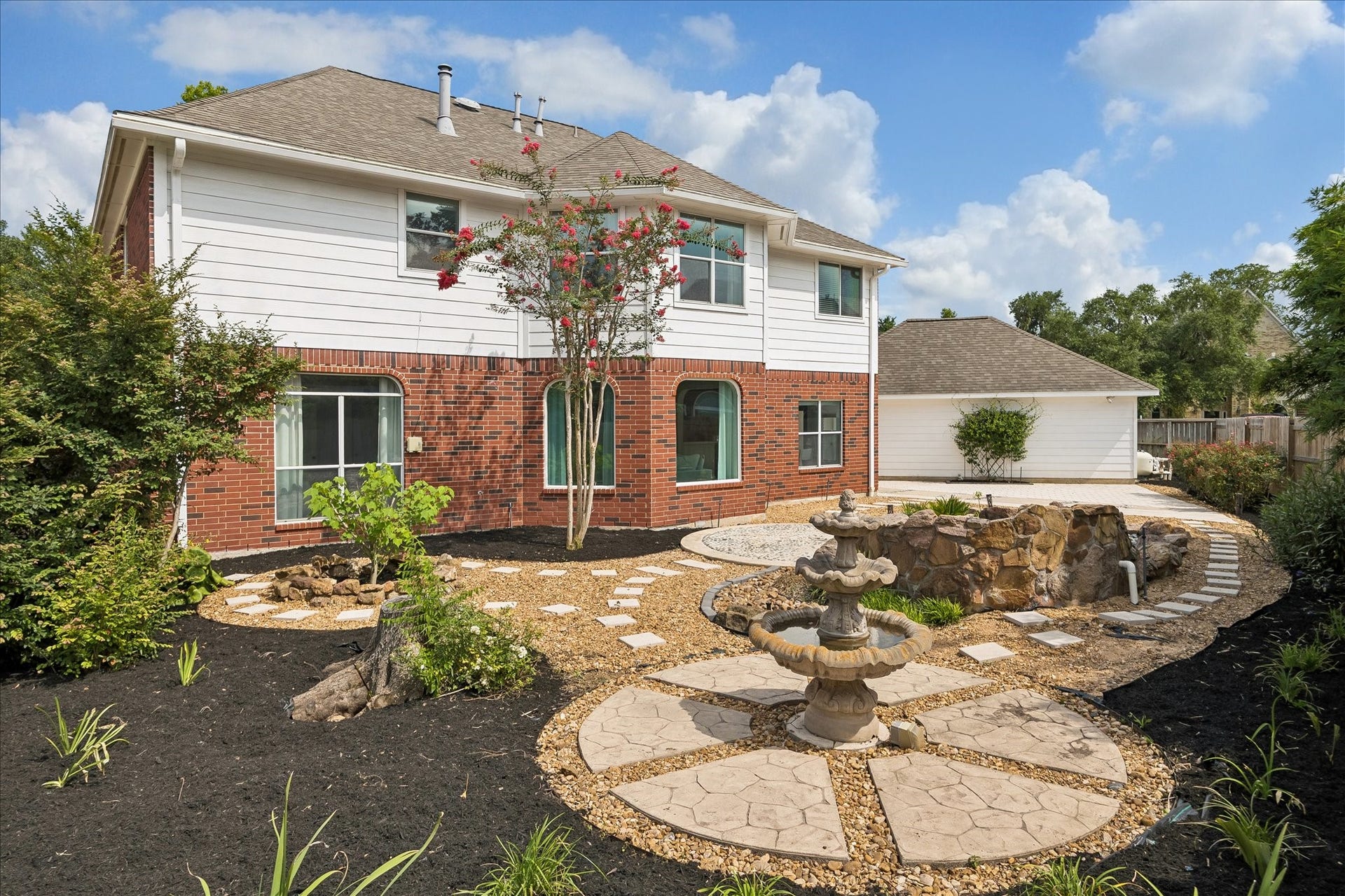 7503 Stone Arbor Drive, Sugar Land, TX 77479 A custom rock feature and decorative bird bath bring a tranquil atmosphere to this low-maintenance backyard. Curved pathways and mature landscape add charm and character throughout the outdoor space.