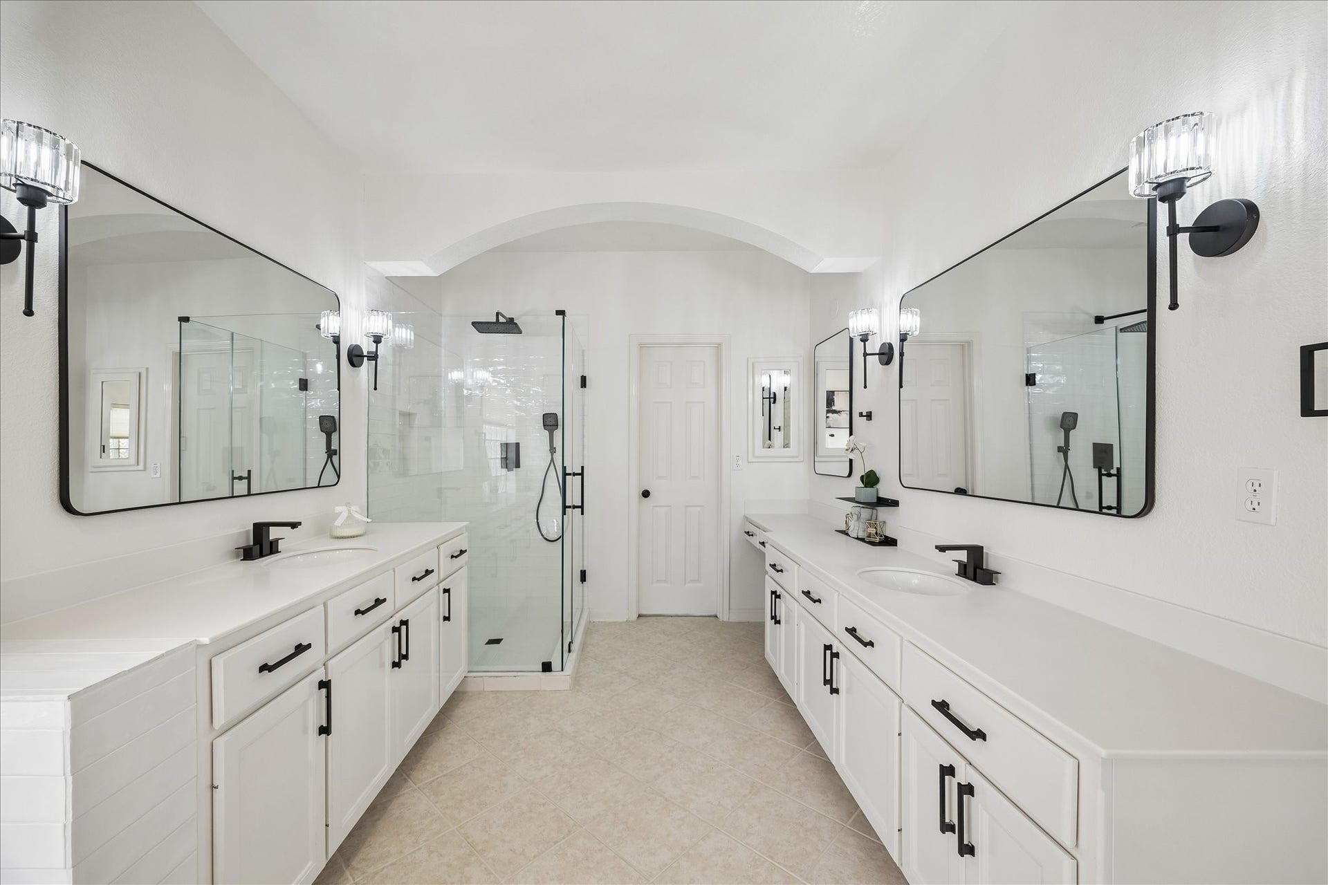 7503 Stone Arbor Drive, Sugar Land, TX 77479 This remodeled spa-inspired bath features dual vanities, framed mirrors, and a stunning walk-in glass shower with designer finishes. A bright, open layout creates a luxurious everyday experience.
