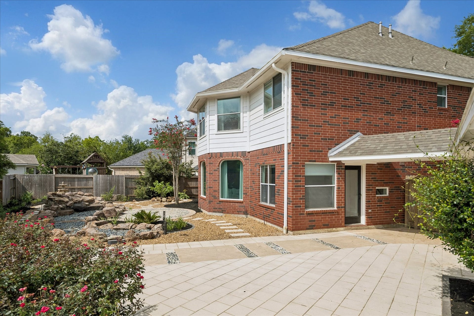 7503 Stone Arbor Drive, Sugar Land, TX 77479 The spacious patio offers plenty of room for outdoor dining, relaxing, or entertaining while overlooking the beautifully designed backyard. Thoughtfully planned landscaping creates a peaceful outdoor retreat.