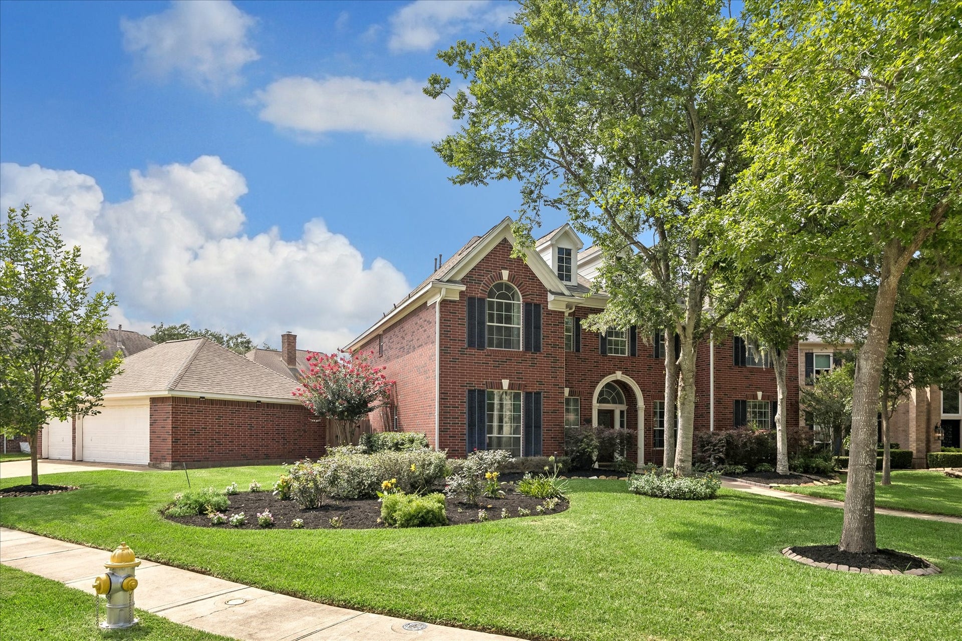 7503 Stone Arbor Drive, Sugar Land, TX 77479 The expansive corner lot provides generous yard space and highlights the home's traditional architecture from every angle. Lush landscaping and a side-entry 3 car garage add to the home's curb appeal.