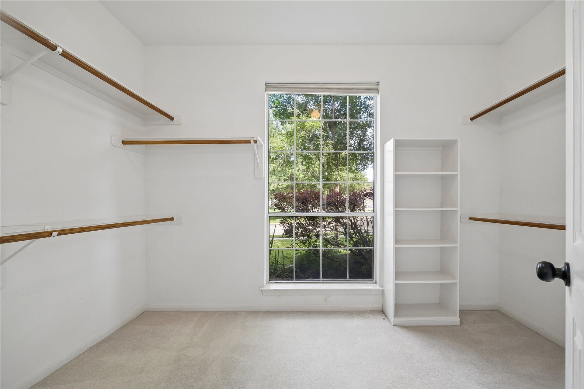 7503 Stone Arbor Drive, Sugar Land, TX 77479 This is one of two walk-in closets and offers abundant hanging space, built-in shelving, and a window that fills the room with natural light. Designed for easy organization, there's plenty of room for every wardrobe.