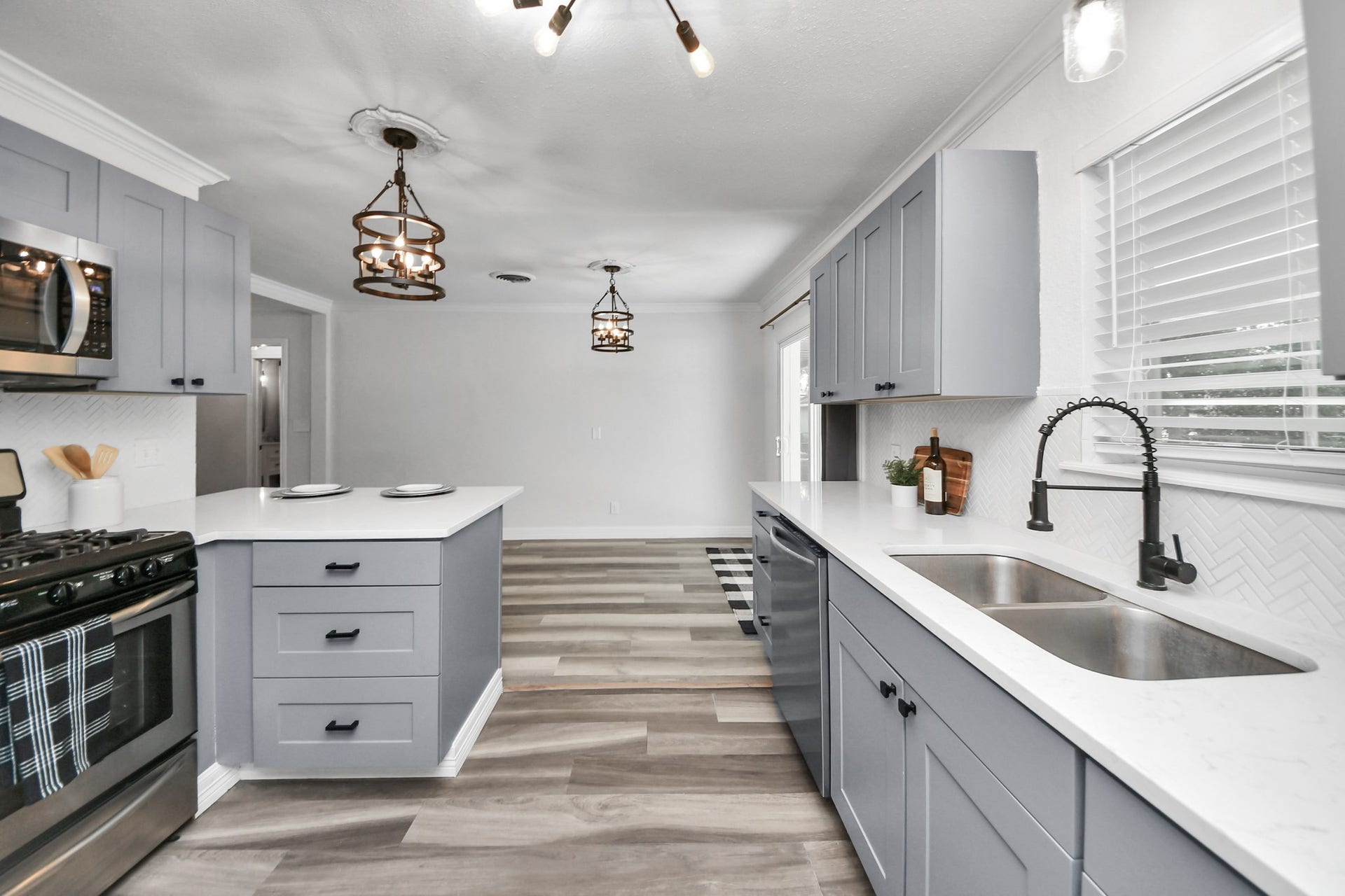 1309 W Lang Street, Alvin, TX 77511 Kitchen with window over the sink, Stainless Steel Appliances overlooking the dining area and backyard access.