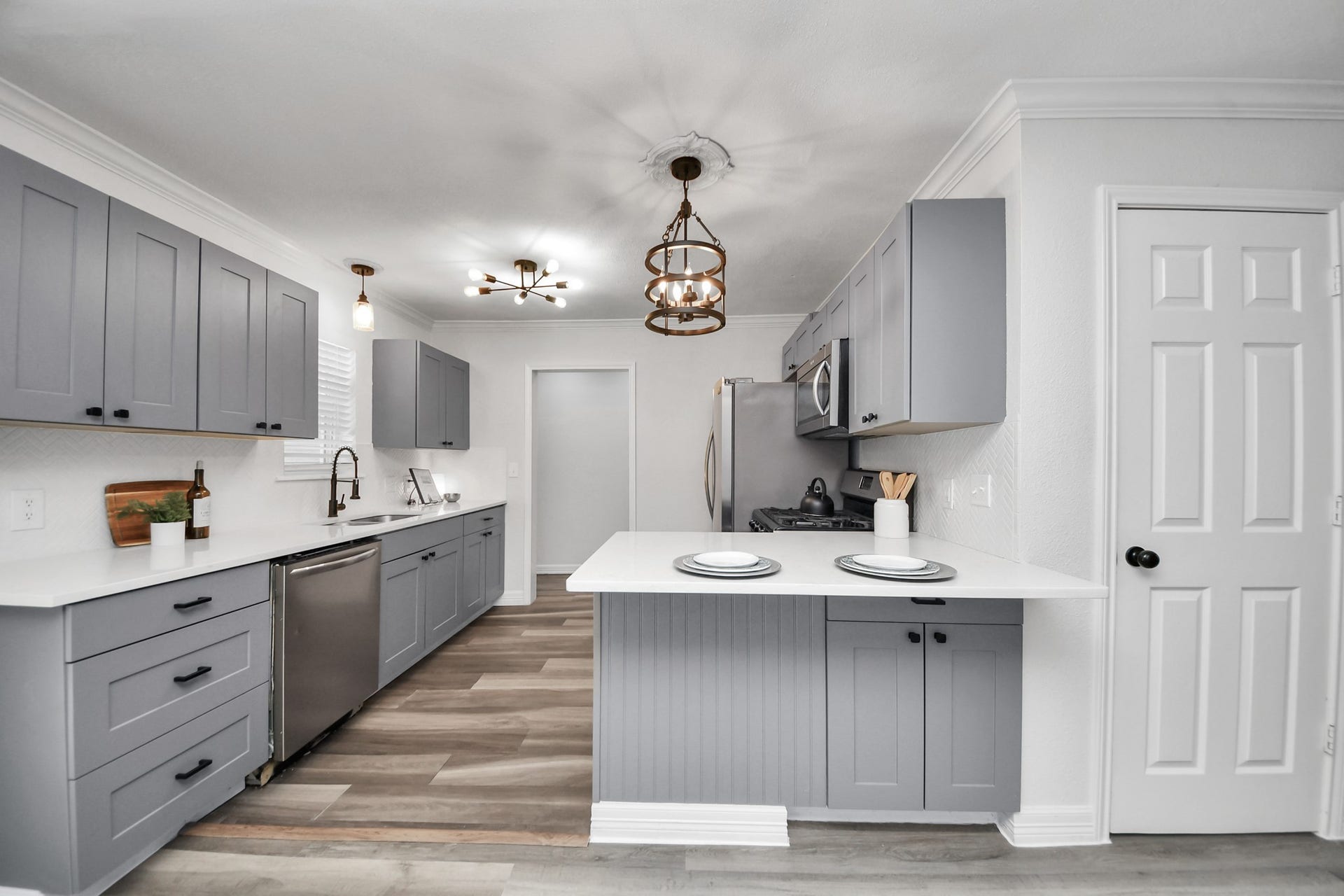 1309 W Lang Street, Alvin, TX 77511 Updated Kitchen with Quartz Counters, Soft close cabinets, and Peninsula breakfast bar. Refrigerator not pictured - but is included! Owner's Primary ensuite through the hallway pictured.