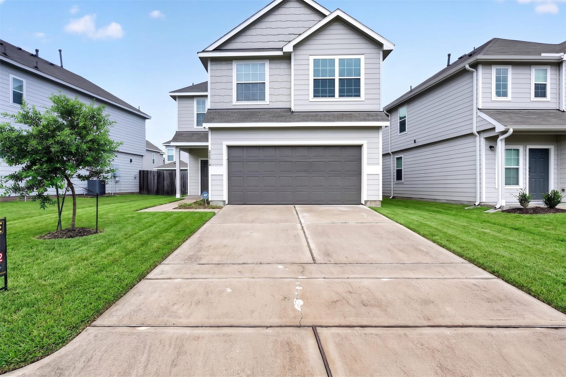 22014 Sovereign Heights Lane, Houston, TX 77073 Front exterior view with driveway and two-car garage.