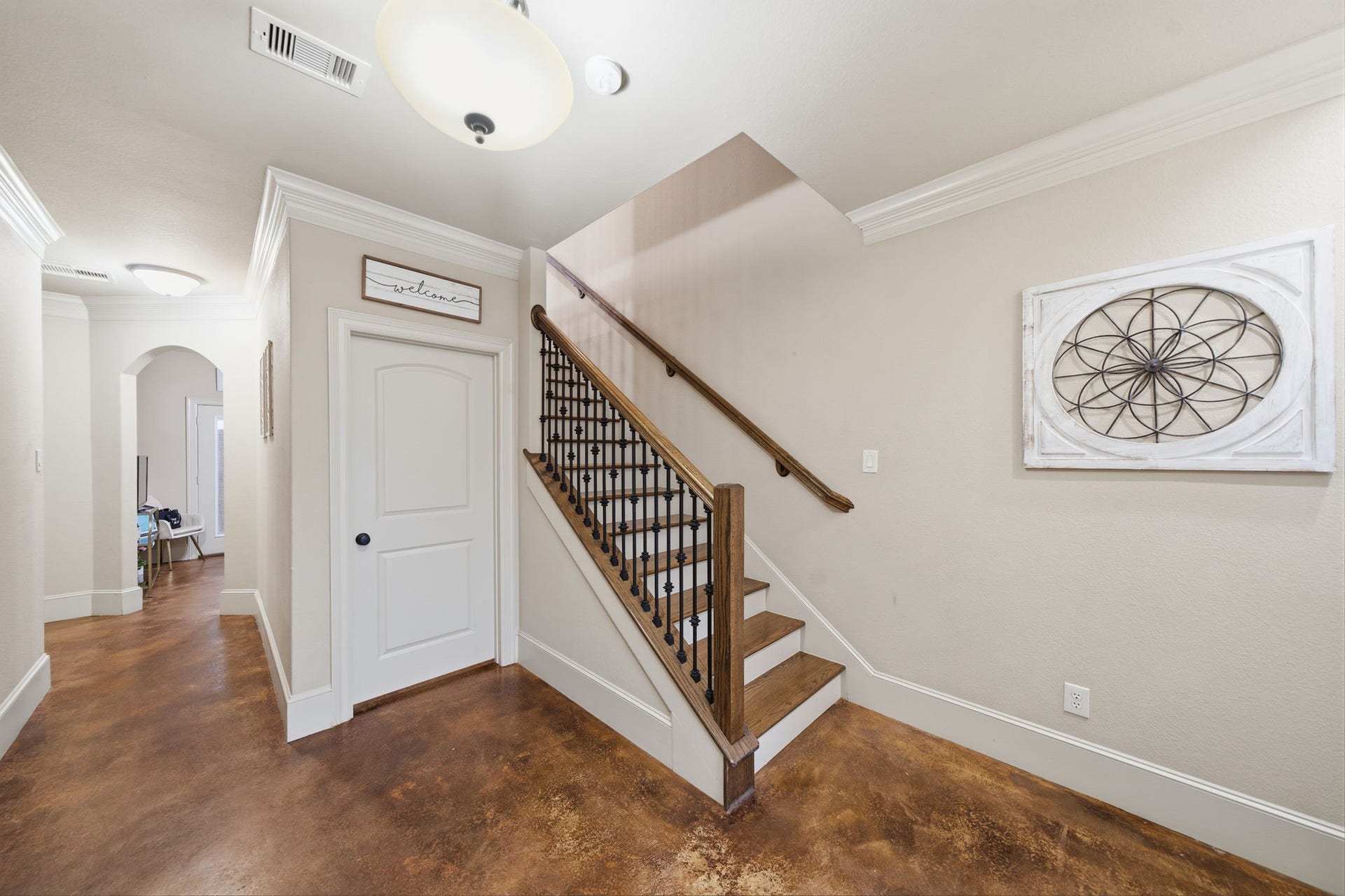 The first floor features stained concrete floors and amazing closet under the stairs, a full guest bath, secondary bedroom and home office (that could easily become a 4th bedroom).