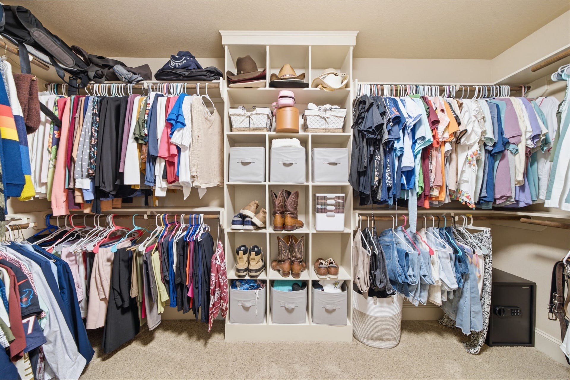 The second primary closet with built in shoe shelving and storage galore.