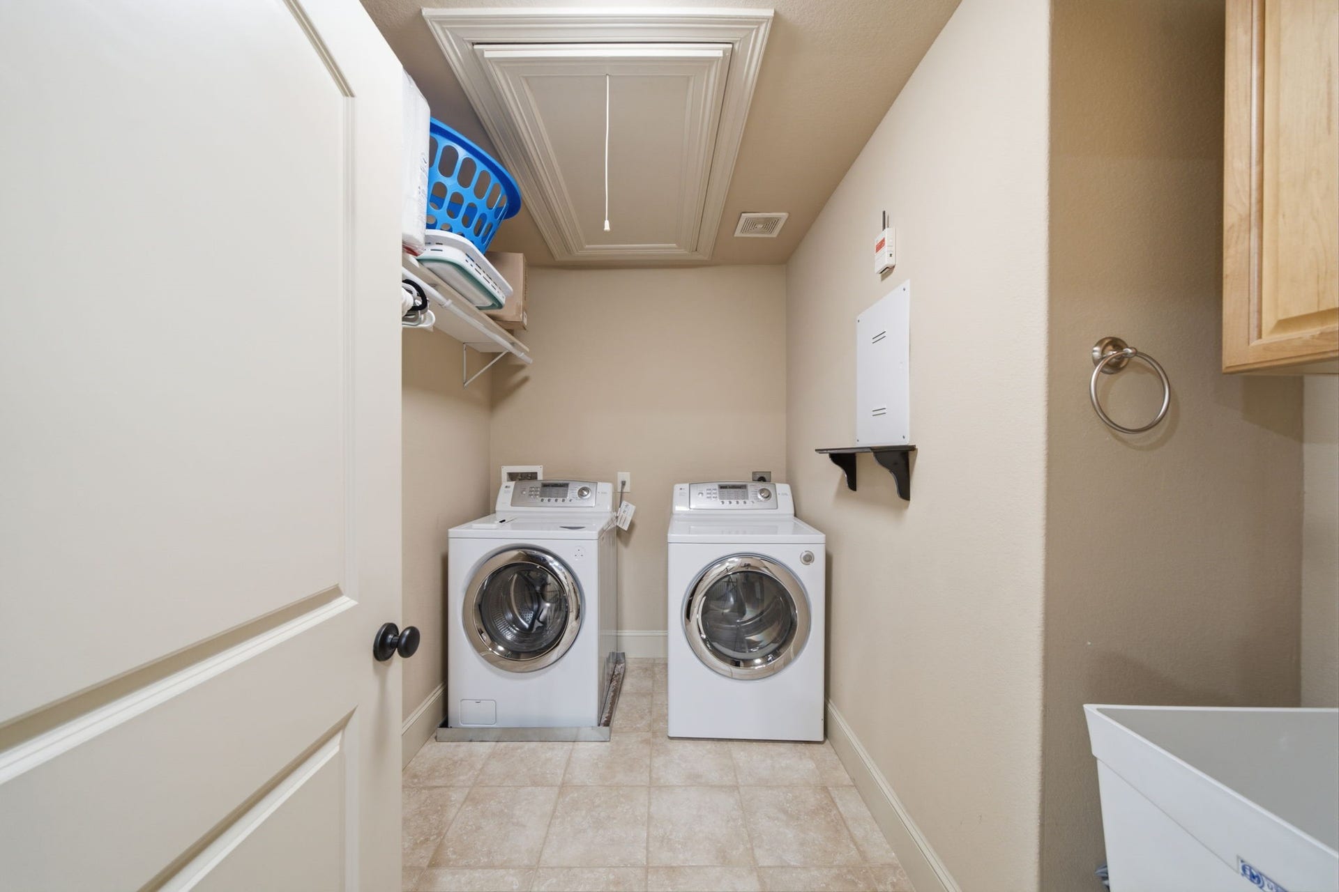 Oversized laundry room has a large laundry sink on the right with ample storage throughout.  There are gas and electric dryer connections (so buyers can bring their appliances of choice).