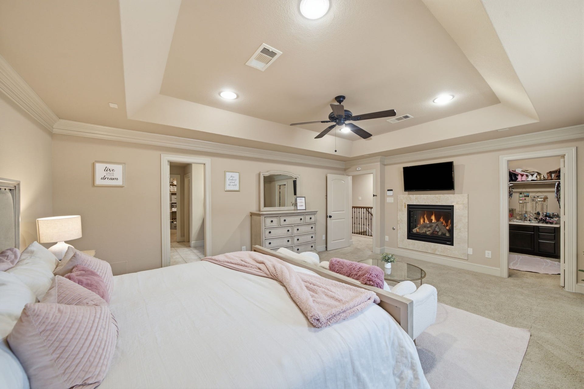This romantic primary suite features a gas log fireplace and 2 ENORMOUS closets!
