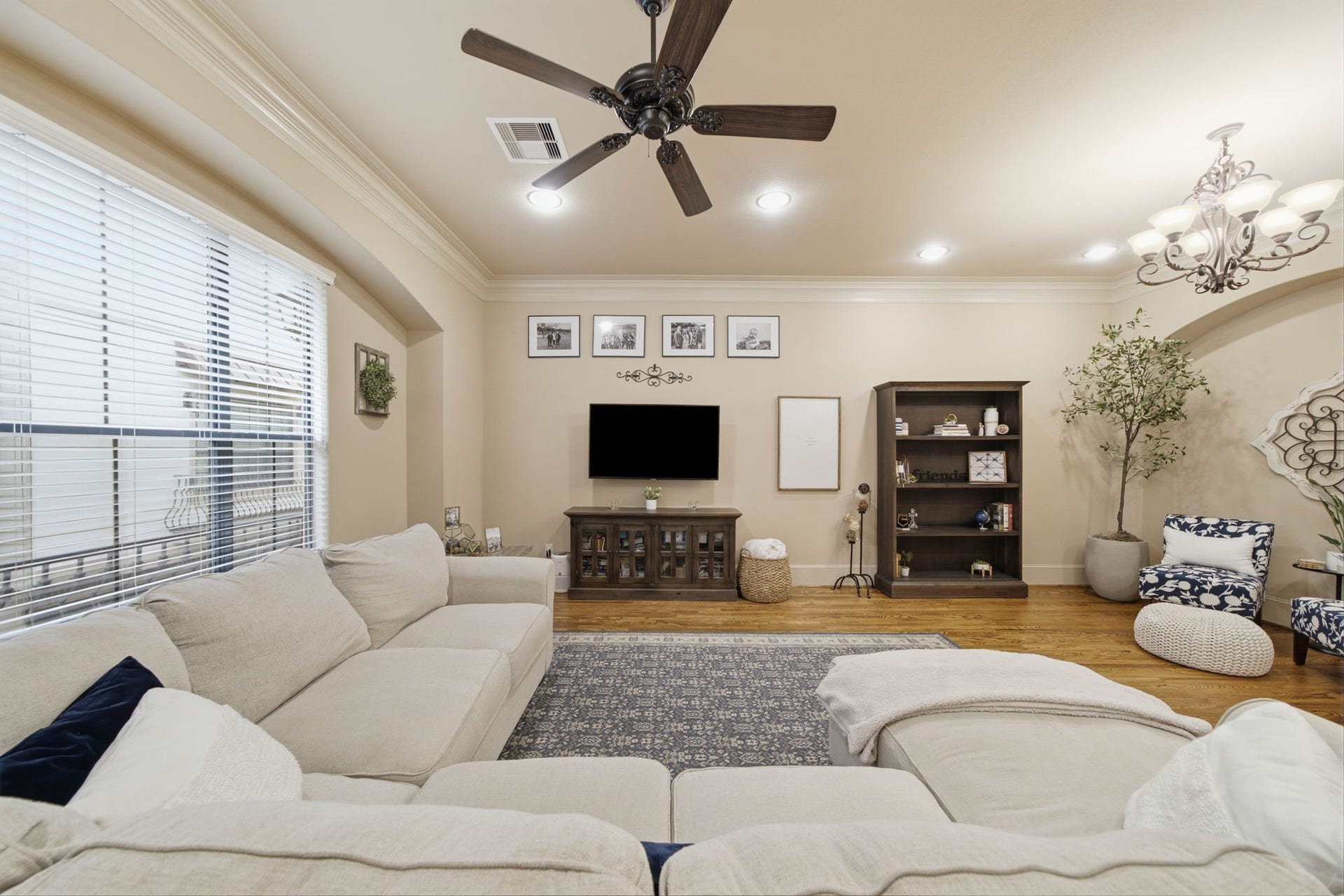 Light and bright living room with a wall of windows and recessed lighting throughout.