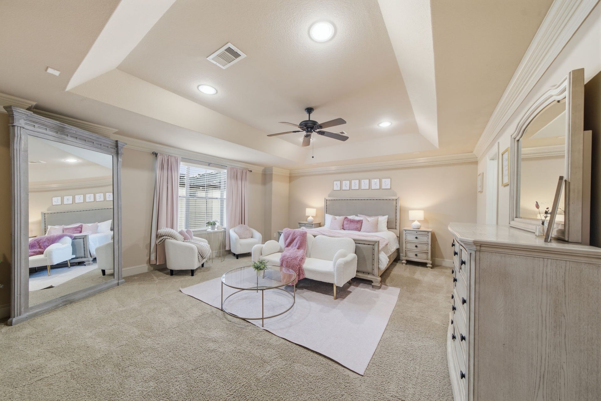 Primary en-suite with tray ceiling and ample space for sitting area, and luxurious en-suite bath.