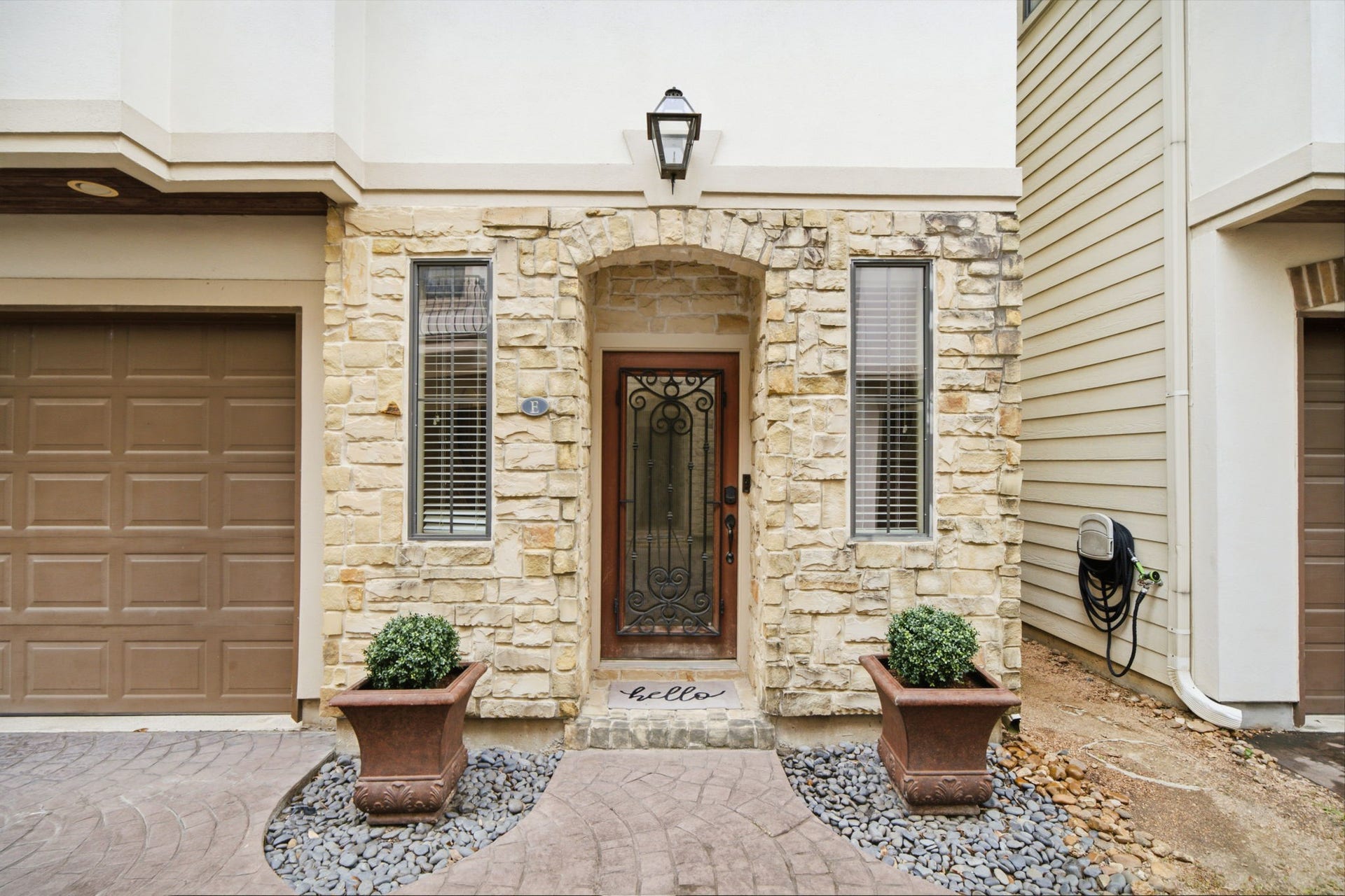 This graceful entry with stone and stucco welcomes you!