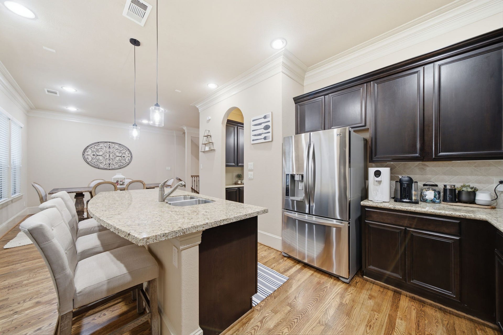 Pendant and recessed lighting.  Spacious island with additional storage and entertaining bar.
