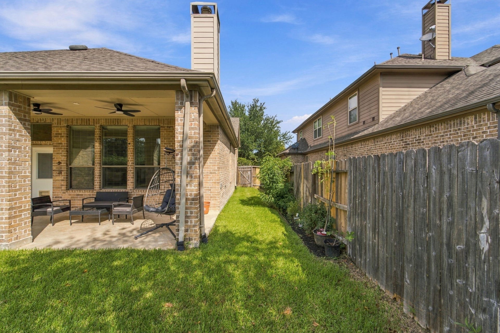 19011 Crest Cove Drive, Cypress, TX 77433 A fenced side yard with a gate makes it easy to move between the front and backyard. Its a practical layout for pets, play, or a little gardening.