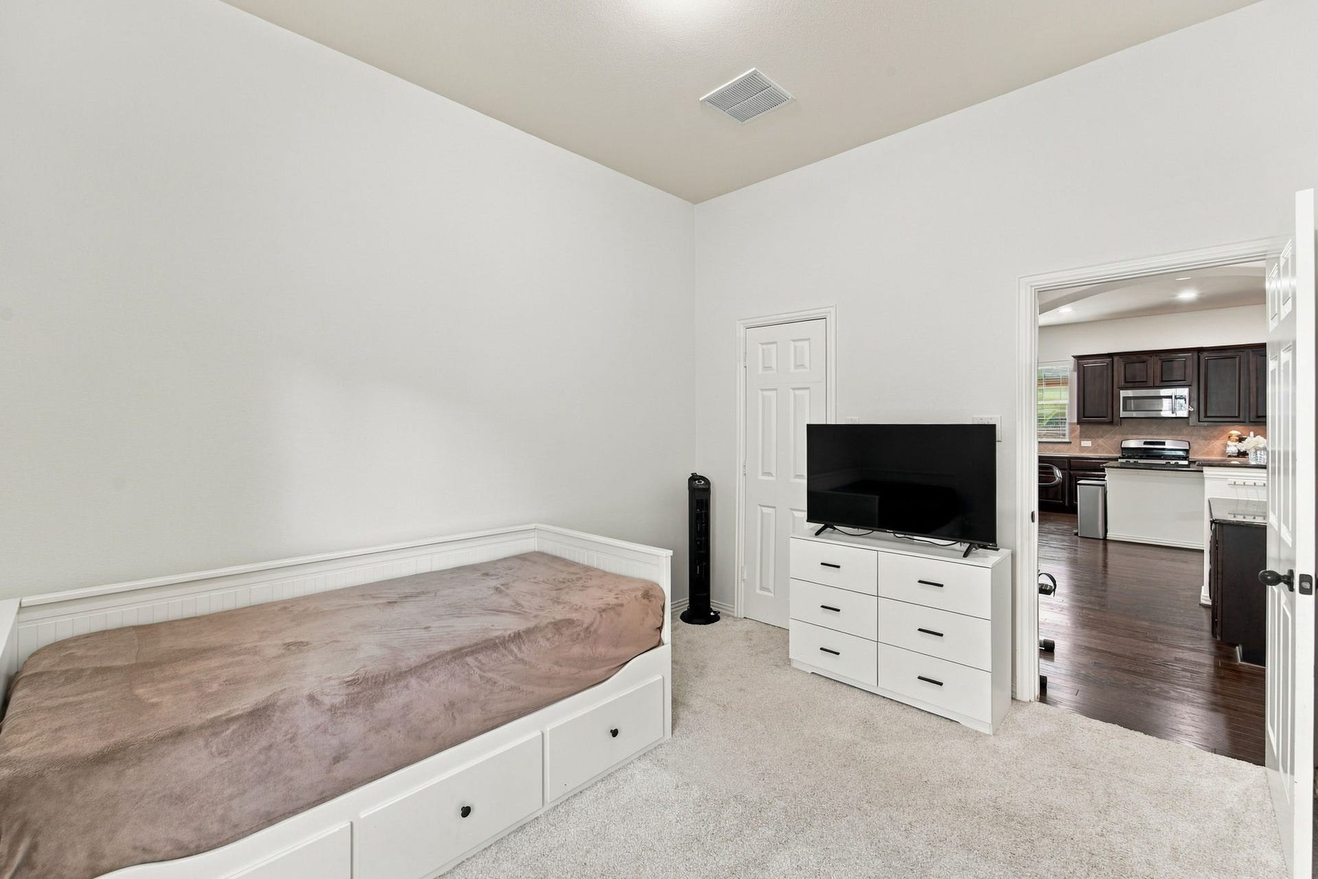 19011 Crest Cove Drive, Cypress, TX 77433 Soft carpet and a closet make this bedroom practical for everyday living, with easy access to the kitchen nearby.