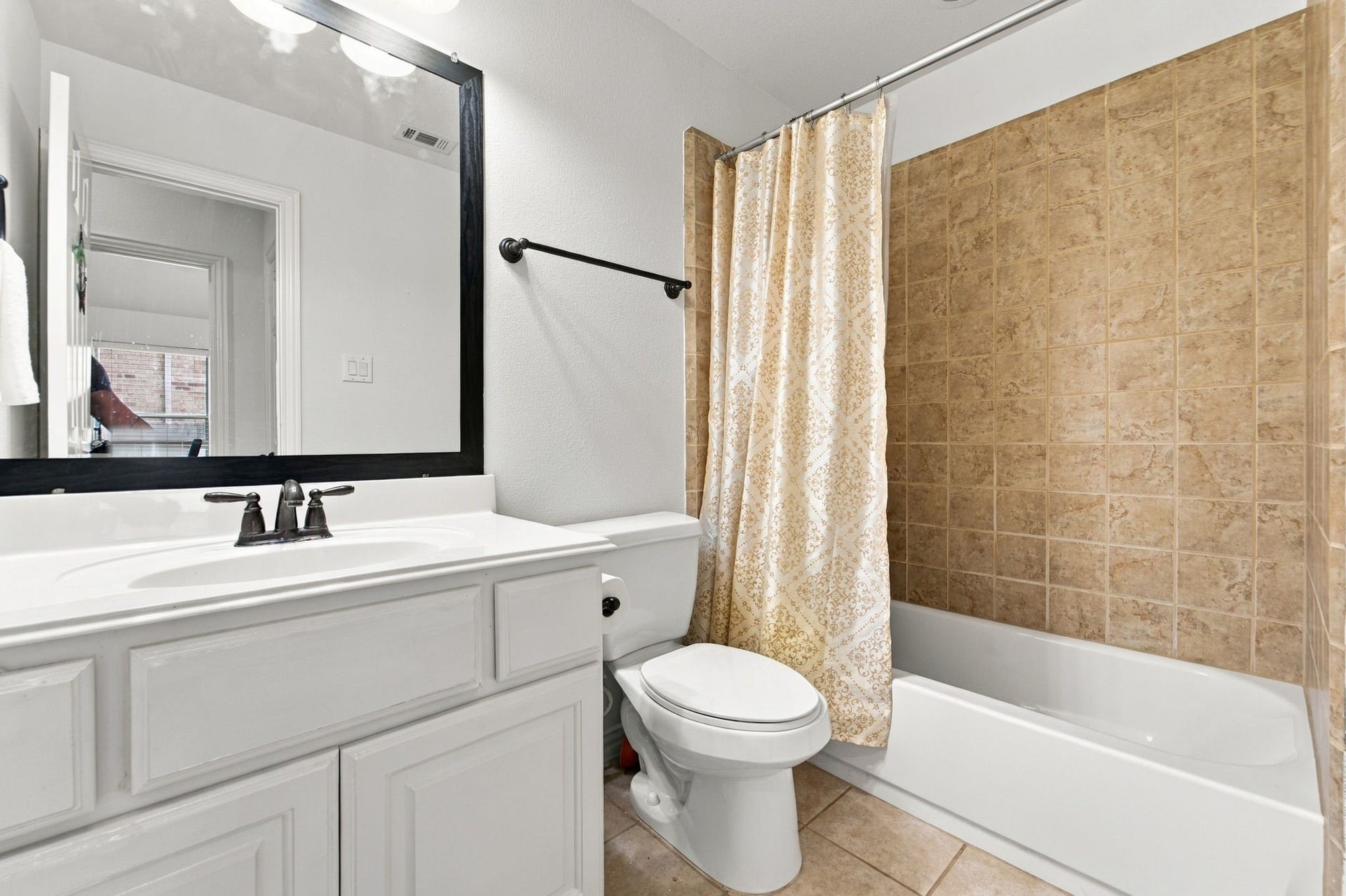 19011 Crest Cove Drive, Cypress, TX 77433 Ready for guests or family, this full bathroom has a tub and shower combination and a single-sink vanity.