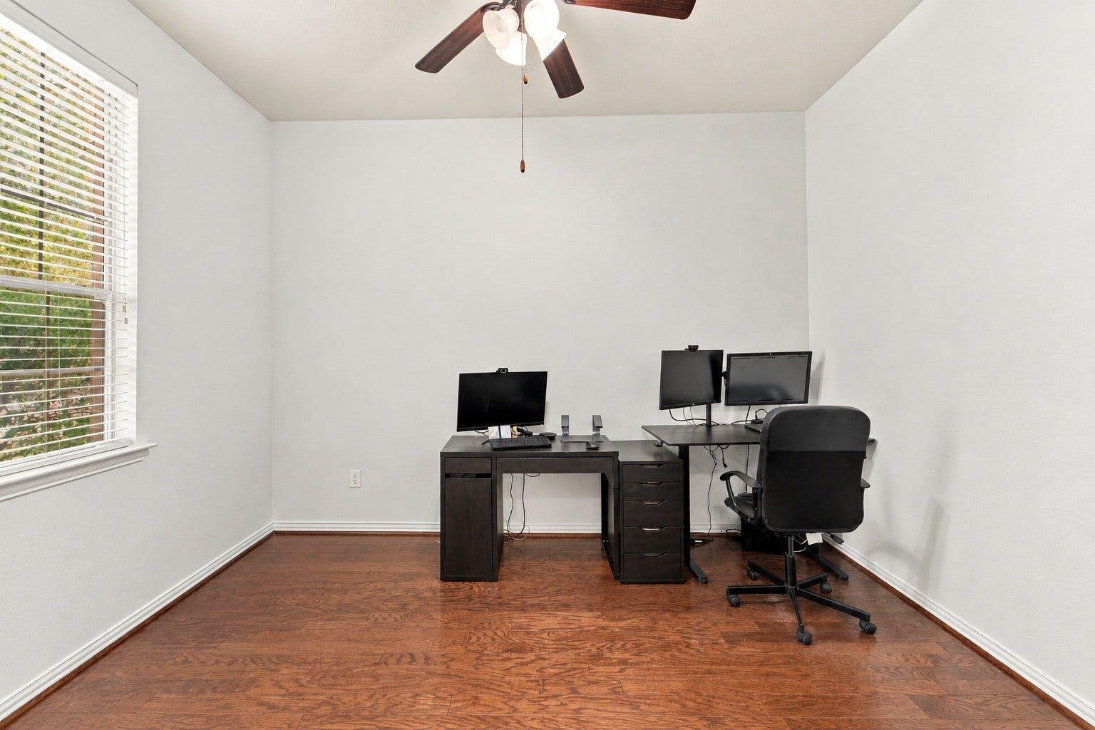 19011 Crest Cove Drive, Cypress, TX 77433 A dedicated home office makes working from home easy. Wood floors, a ceiling fan, and a large window bring in natural light, and theres plenty of room for a desk and workstation. Edited using AI tools.
