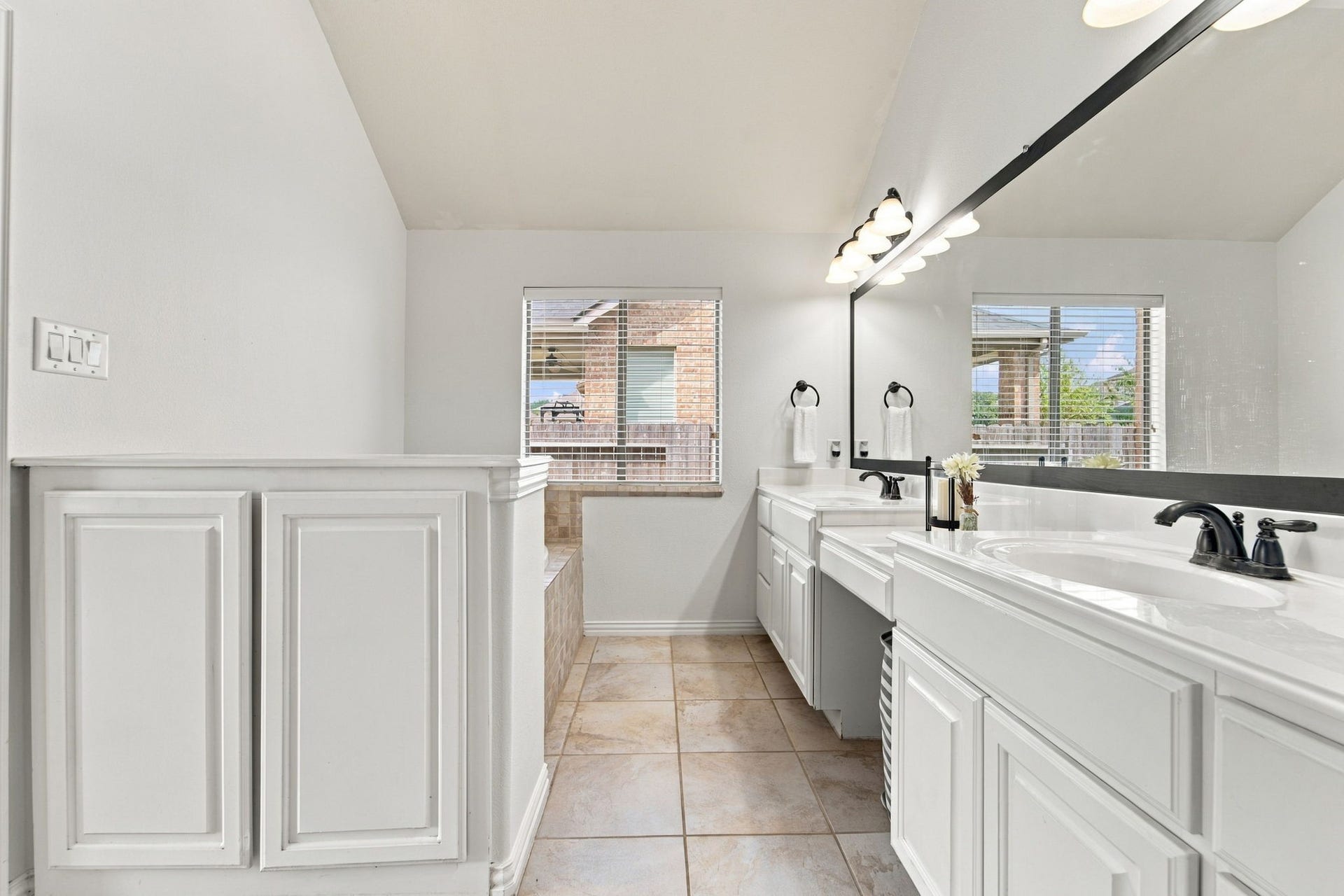 19011 Crest Cove Drive, Cypress, TX 77433 Double sinks and generous counter space make busy mornings easier in this primary bath. Its paired with a soaking tub and a separate shower, a layout that works well for everyday routines.