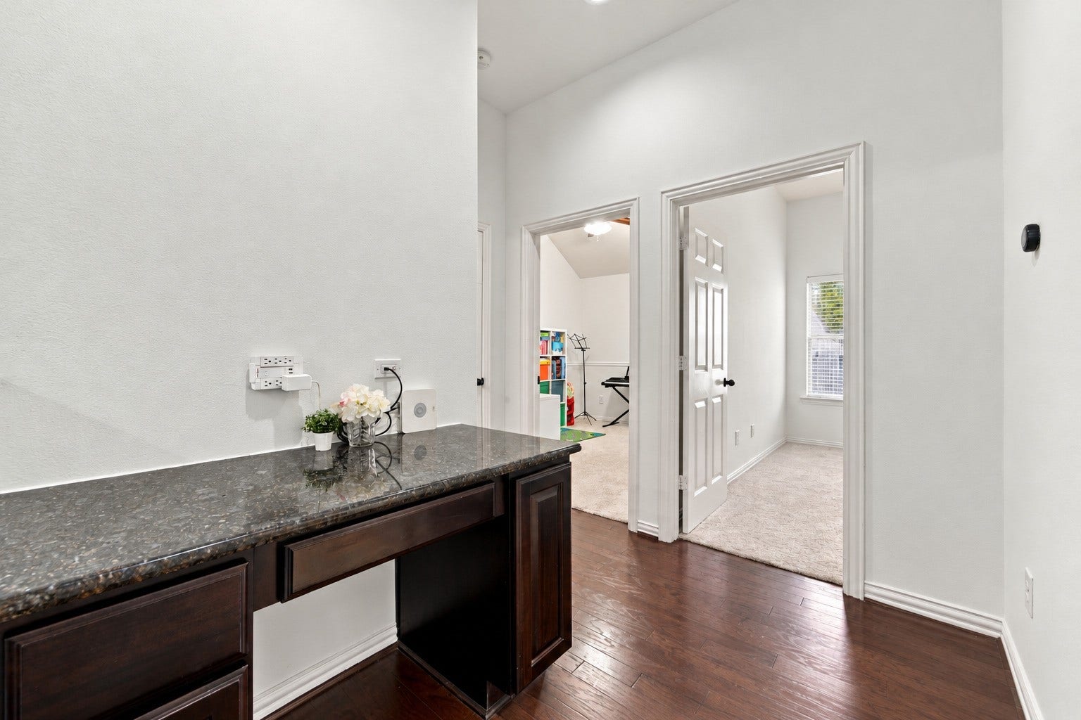 19011 Crest Cove Drive, Cypress, TX 77433 Charming built-in nook featuring granite countertops, rich cabinetry, and convenient storage. This versatile space is perfect for a coffee station, homework area, or everyday organization.