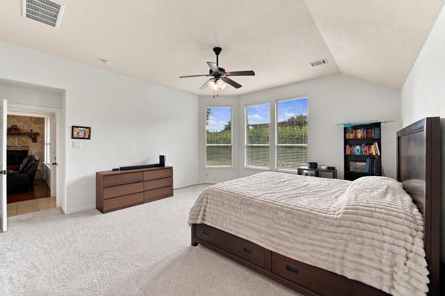 19011 Crest Cove Drive, Cypress, TX 77433 Wake up to green views through a trio of windows in this oversized primary bedroom. A direct connection to the main living area keeps everything convenient on a single level. Edited using AI tools.