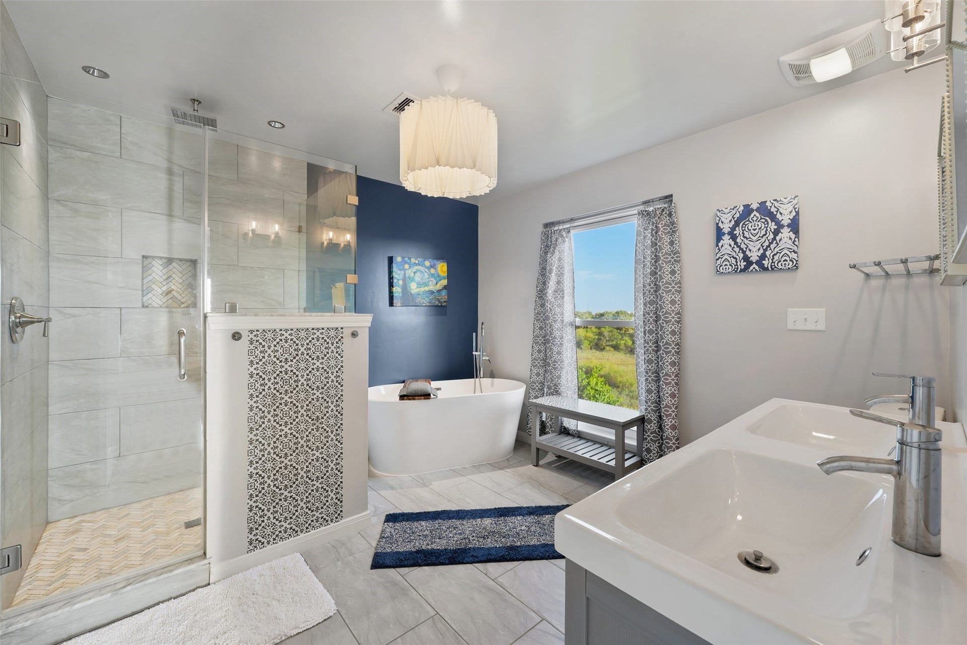 22513 Bay Point Drive, Galveston, TX 77554 The primary bathroom features tile floors, dual sinks, custom paint, spacious walk-in shower, and separate tub.