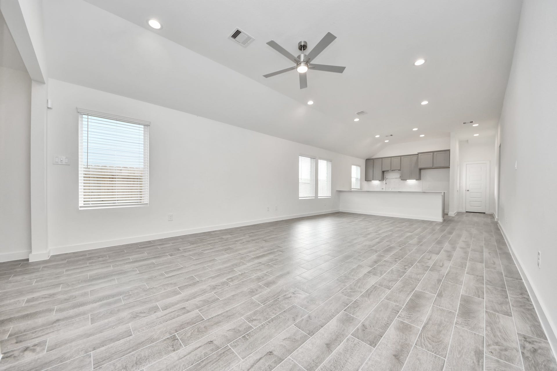 5830 Madison Trail Drive, Richmond, TX 77469 Welcome family and guests to your charming living room! With its high ceilings, recessed lighting, ceiling fan, custom paint, beautiful flooring, and large windows that let in abundant natural light, this room is perfect for gatherings. Sample photo of completed home with similar floor plan. Actual colors and selections may vary.