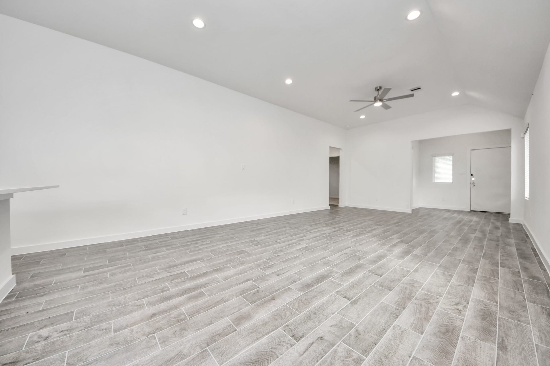 5830 Madison Trail Drive, Richmond, TX 77469 Family room flooded with natural light through the expansive windows. The premium tile flooring adds a touch of luxury to the space, creating the perfect setting for relaxing moments and cherished gatherings with loved ones. Sample photo of completed home with similar floor plan. Actual colors and selections may vary.