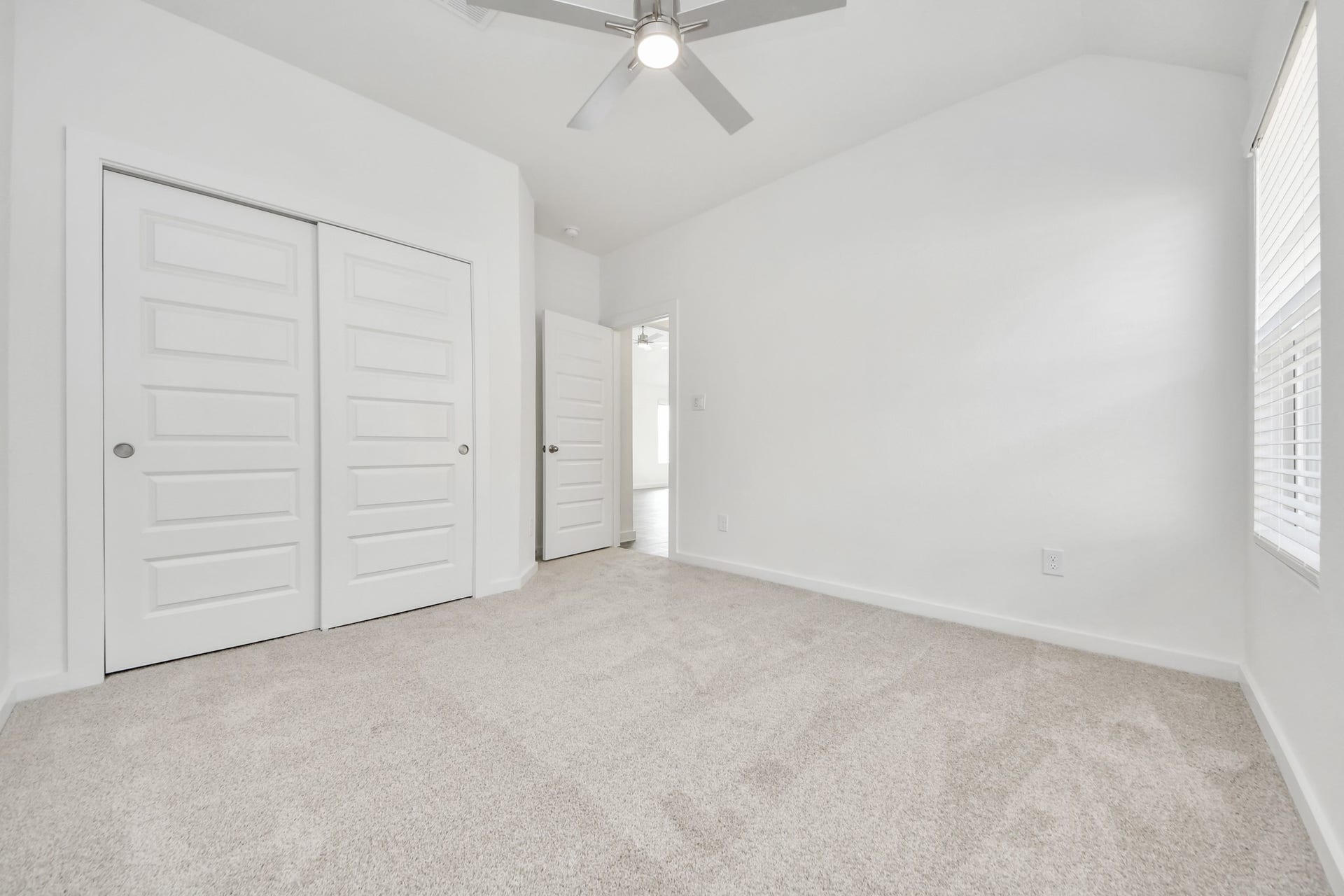 5830 Madison Trail Drive, Richmond, TX 77469 Secondary bedroom features plush carpeting, large windows that let in plenty of natural light, bright paint, and spacious closets. Sample photo of completed home with similar floor plan. Actual colors and selections may vary.