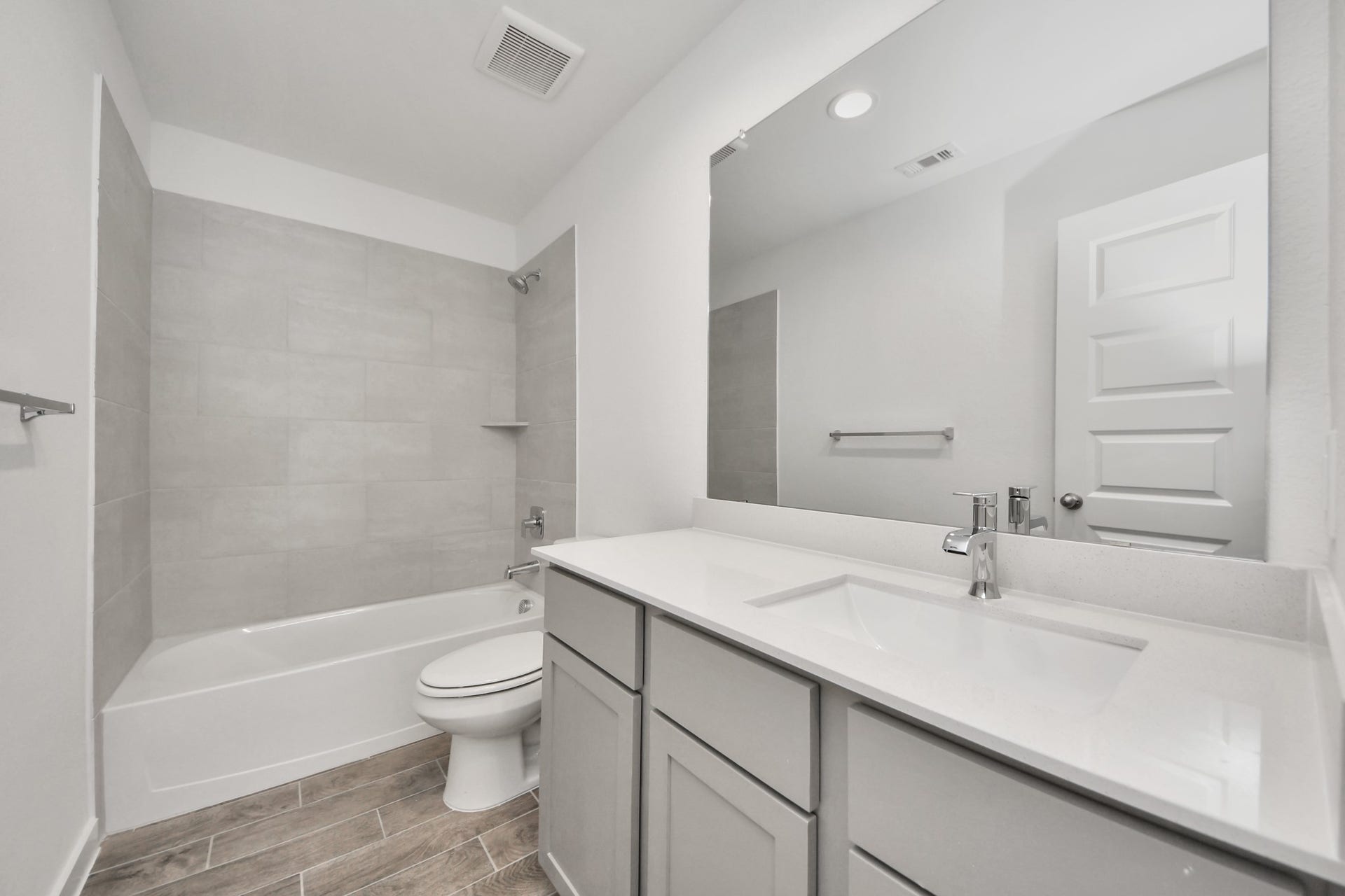 5830 Madison Trail Drive, Richmond, TX 77469 Secondary bath features tile flooring, bath/shower combo with tile surround, light stained wood cabinets, beautiful light countertop. Sample photo of completed home with similar floor plan. Actual colors and selections may vary.