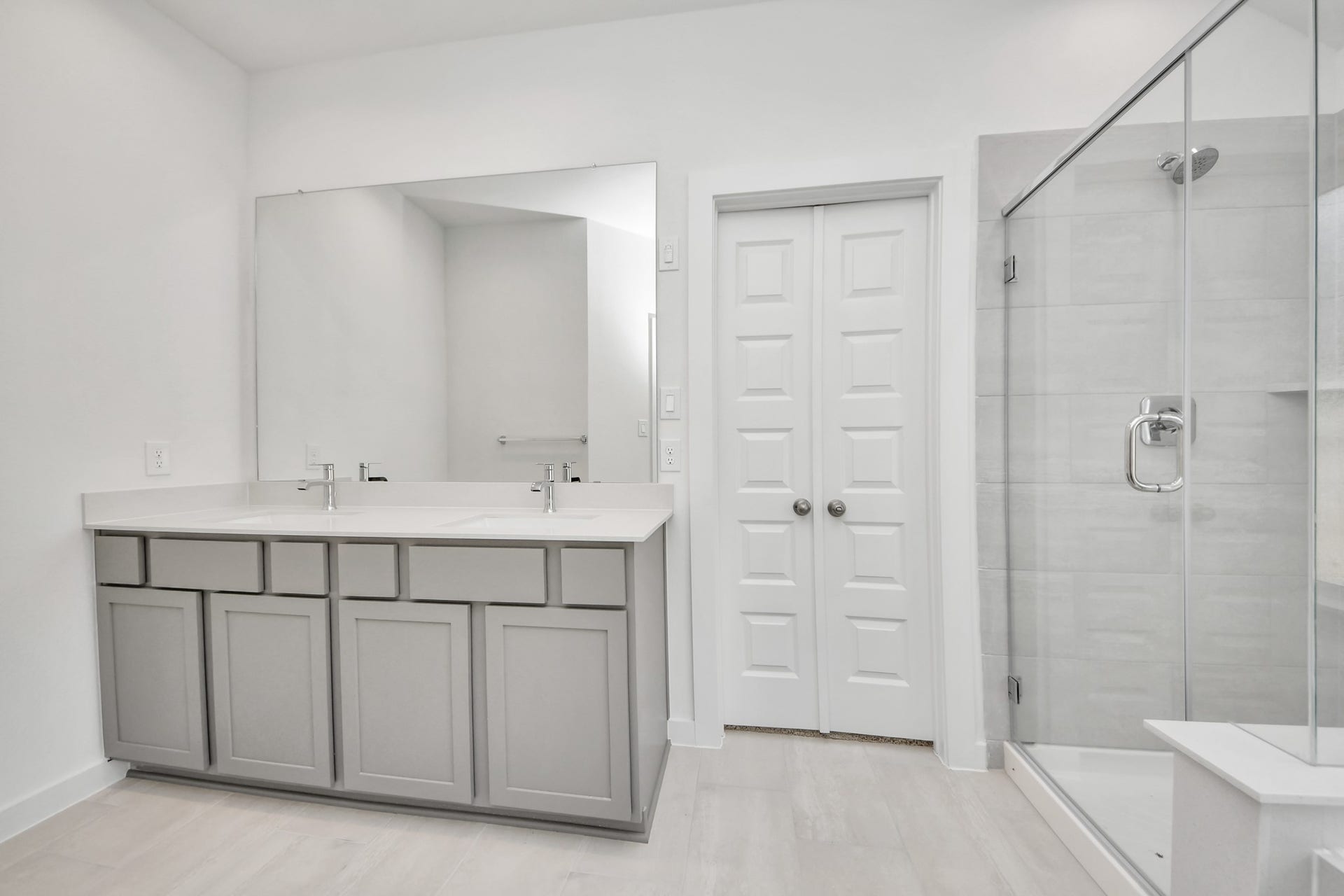 5830 Madison Trail Drive, Richmond, TX 77469 Elevate your daily routine at the elegant vanity, now equipped with double sinks, light countertops, modern hardware, and beautiful recessed lights. Sample photo of completed home with similar floor plan. Actual colors and selections may vary.