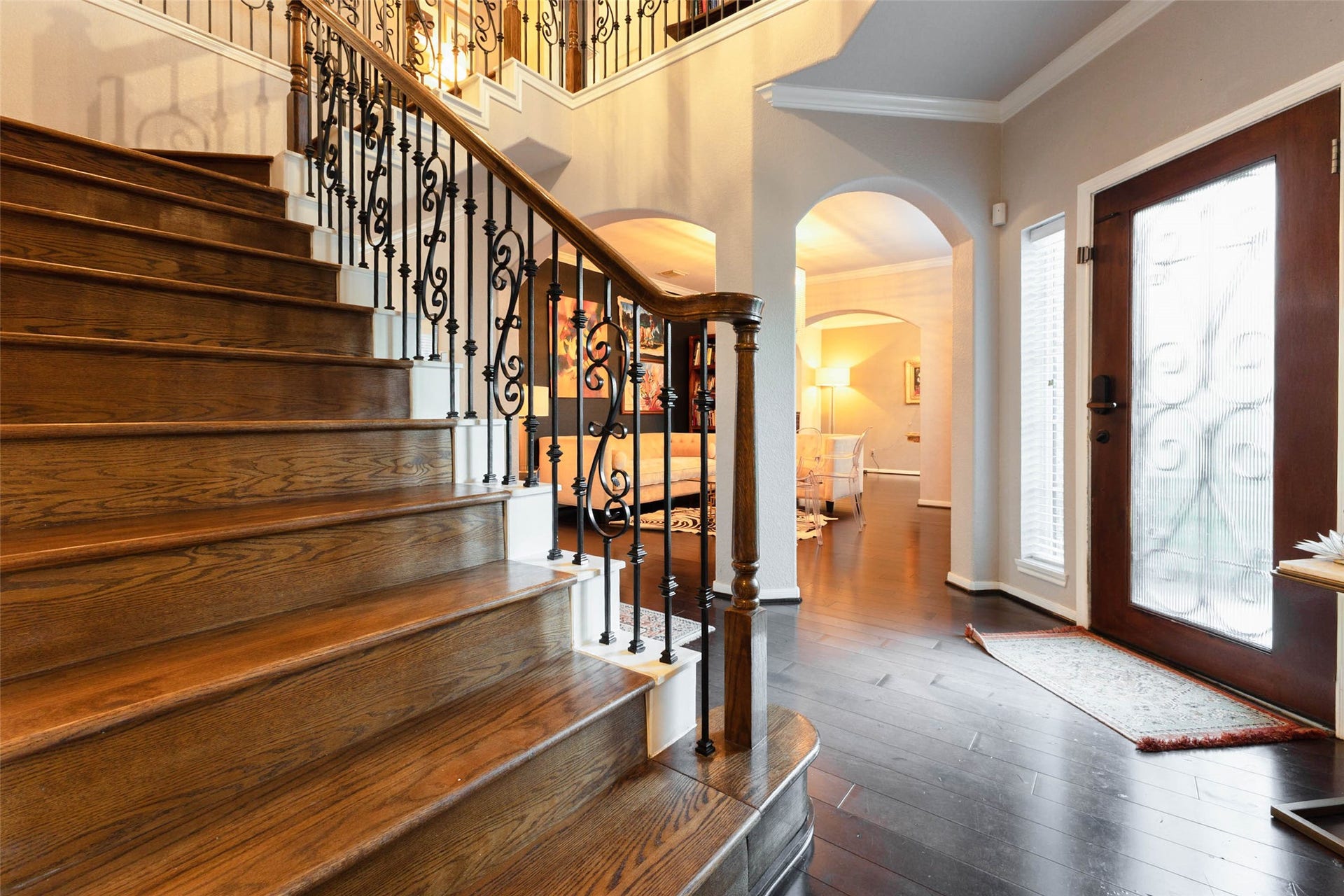 25734 Jewel Springs Lane, Katy, TX 77494 Stately wood steps and decorative iron balusters create a striking focal point beneath the soaring foyer ceiling.