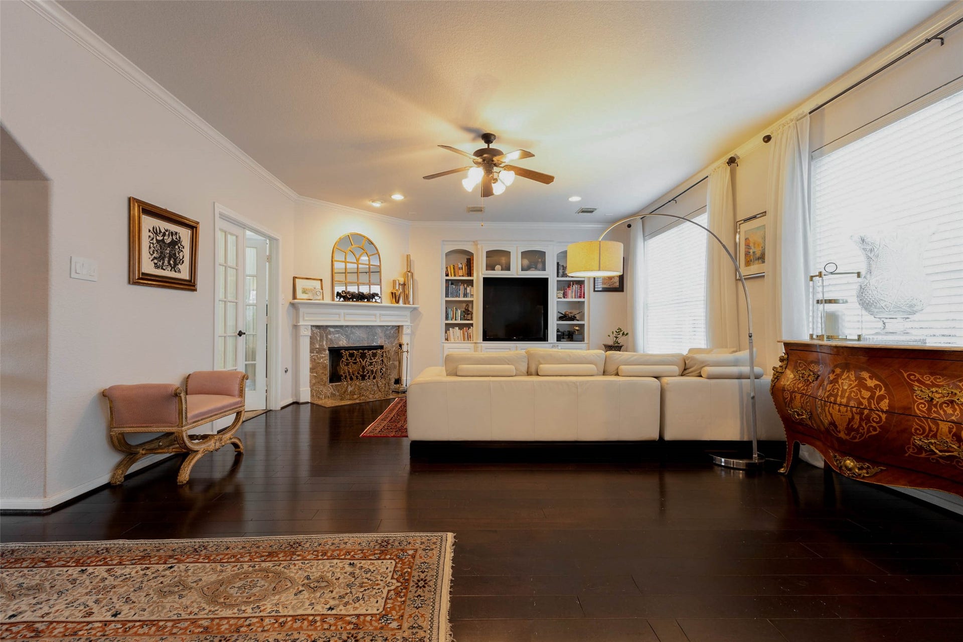 25734 Jewel Springs Lane, Katy, TX 77494 Expansive hardwood flooring connects the main living spaces, while a fireplace & custom entertainment built-ins establish a comfortable gathering place.