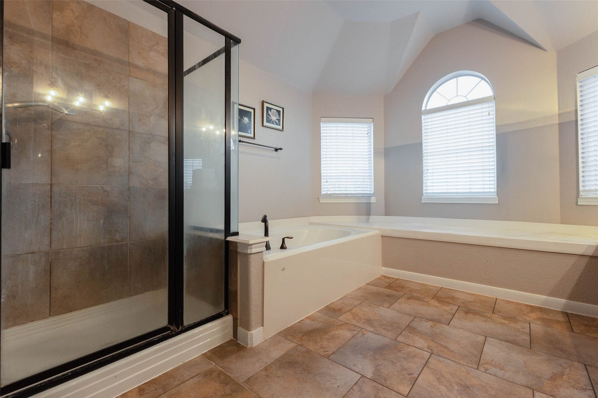 25734 Jewel Springs Lane, Katy, TX 77494 This primary bath features a soaking tub, separate glass-enclosed shower & inviting sitting ledge.
