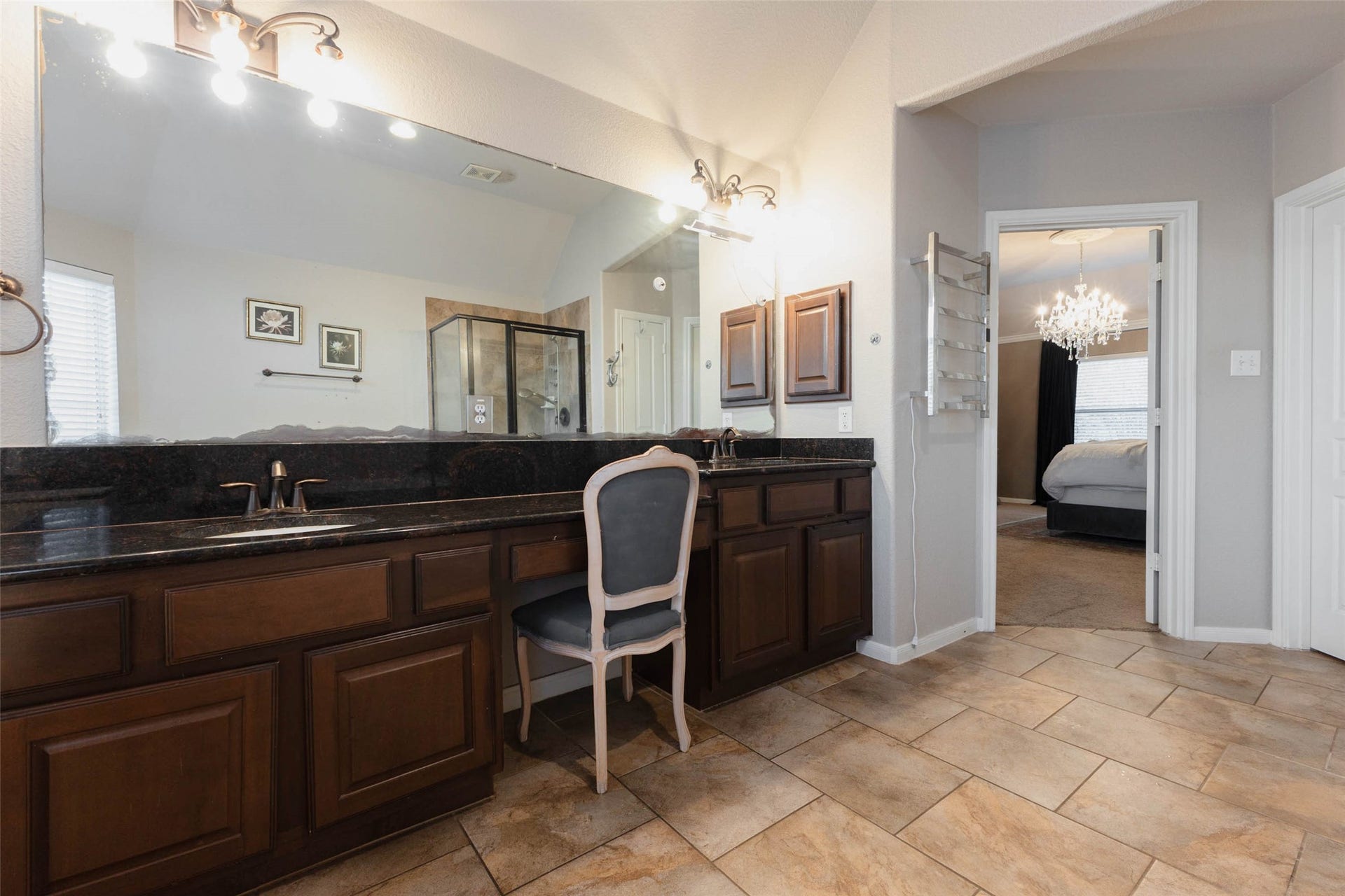 25734 Jewel Springs Lane, Katy, TX 77494 A double-sink vanity pairs dark granite countertops with rich wood cabinetry & ample storage.