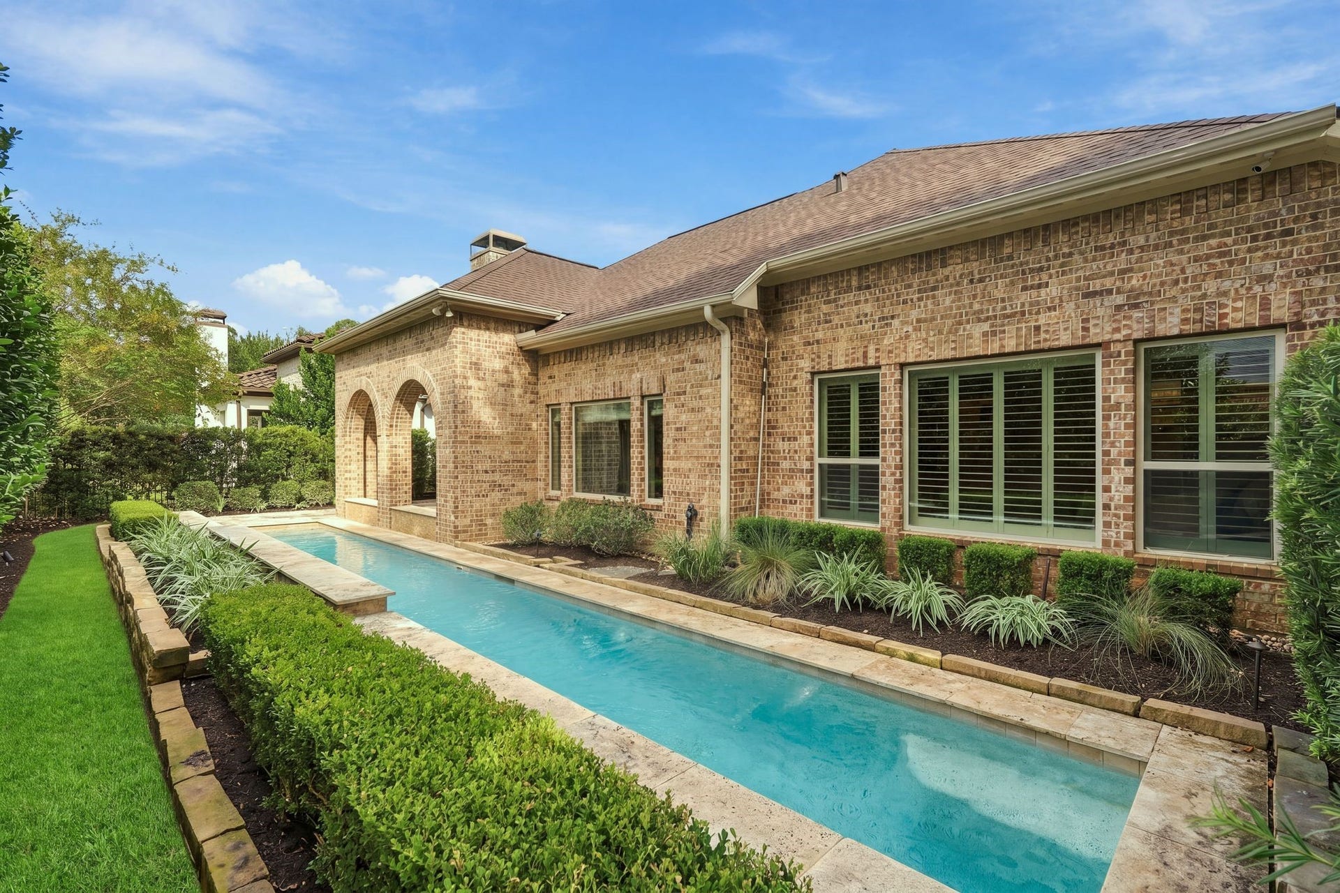 51 Woodglade Way, The Woodlands, TX 77375 Lap pool with waterfalls makes this backyard a peaceful paradise.