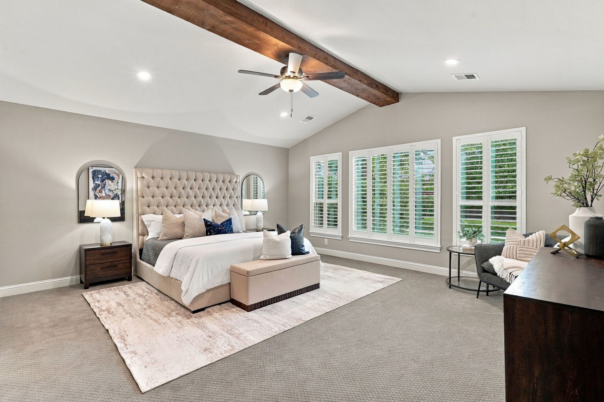 51 Woodglade Way, The Woodlands, TX 77375 Spacious primary bedroom with plantation shutters, wood beams, new carpet.