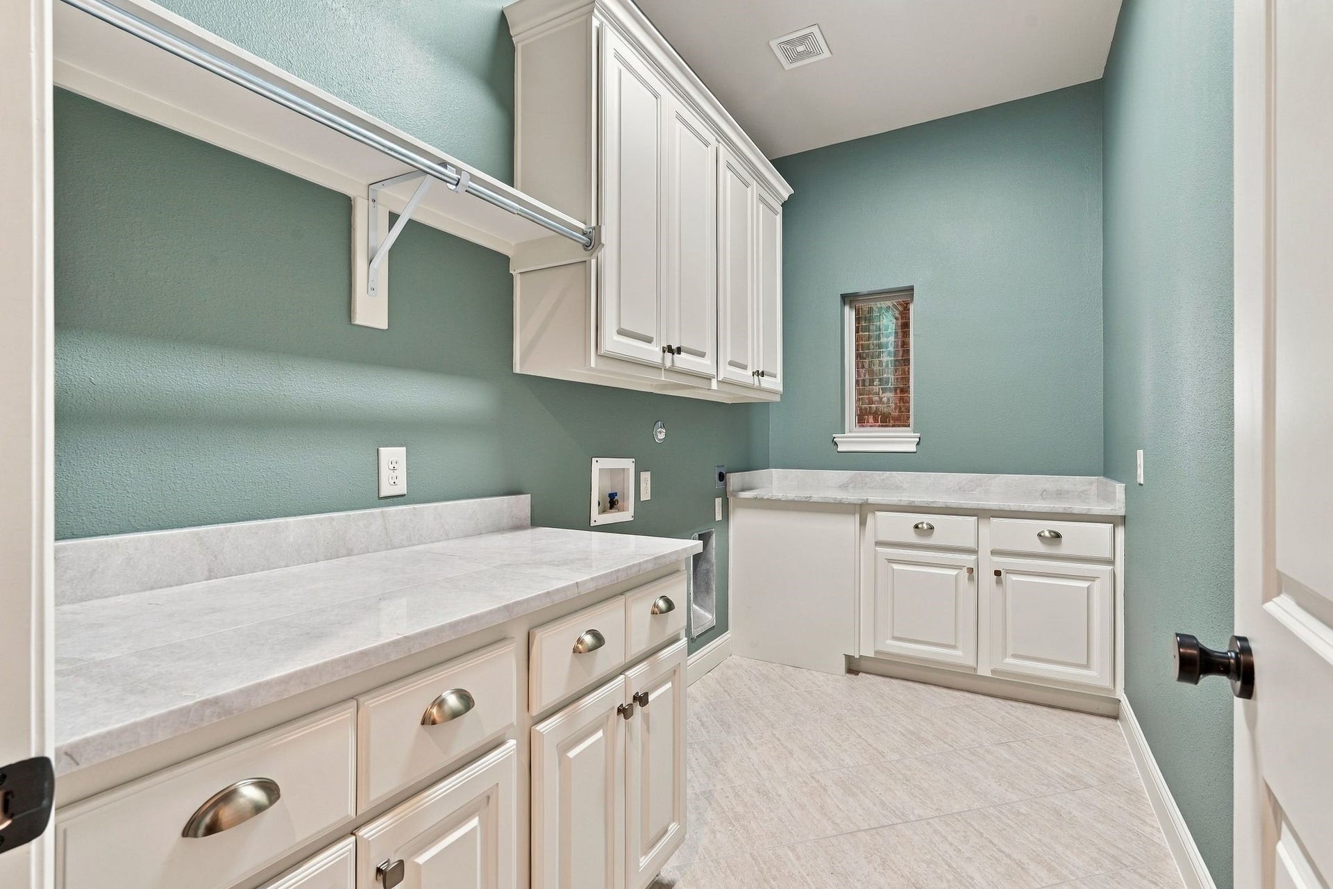 51 Woodglade Way, The Woodlands, TX 77375 Painted cabinets, new hardware Taj Mahal quartzite countertops in this lovely laundry room!