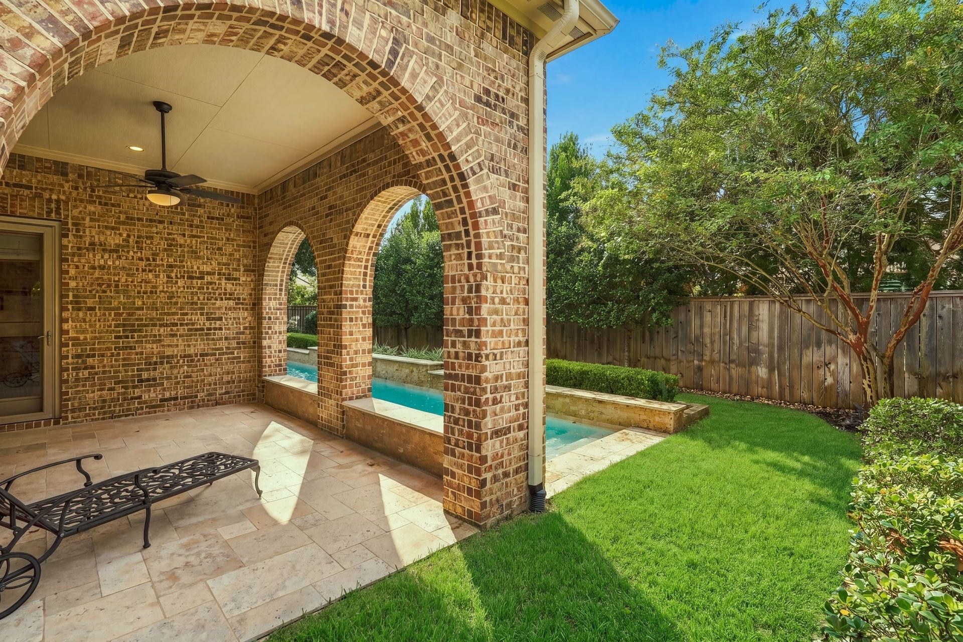 51 Woodglade Way, The Woodlands, TX 77375 Covered patio overlooking the pool and lush landscaping.